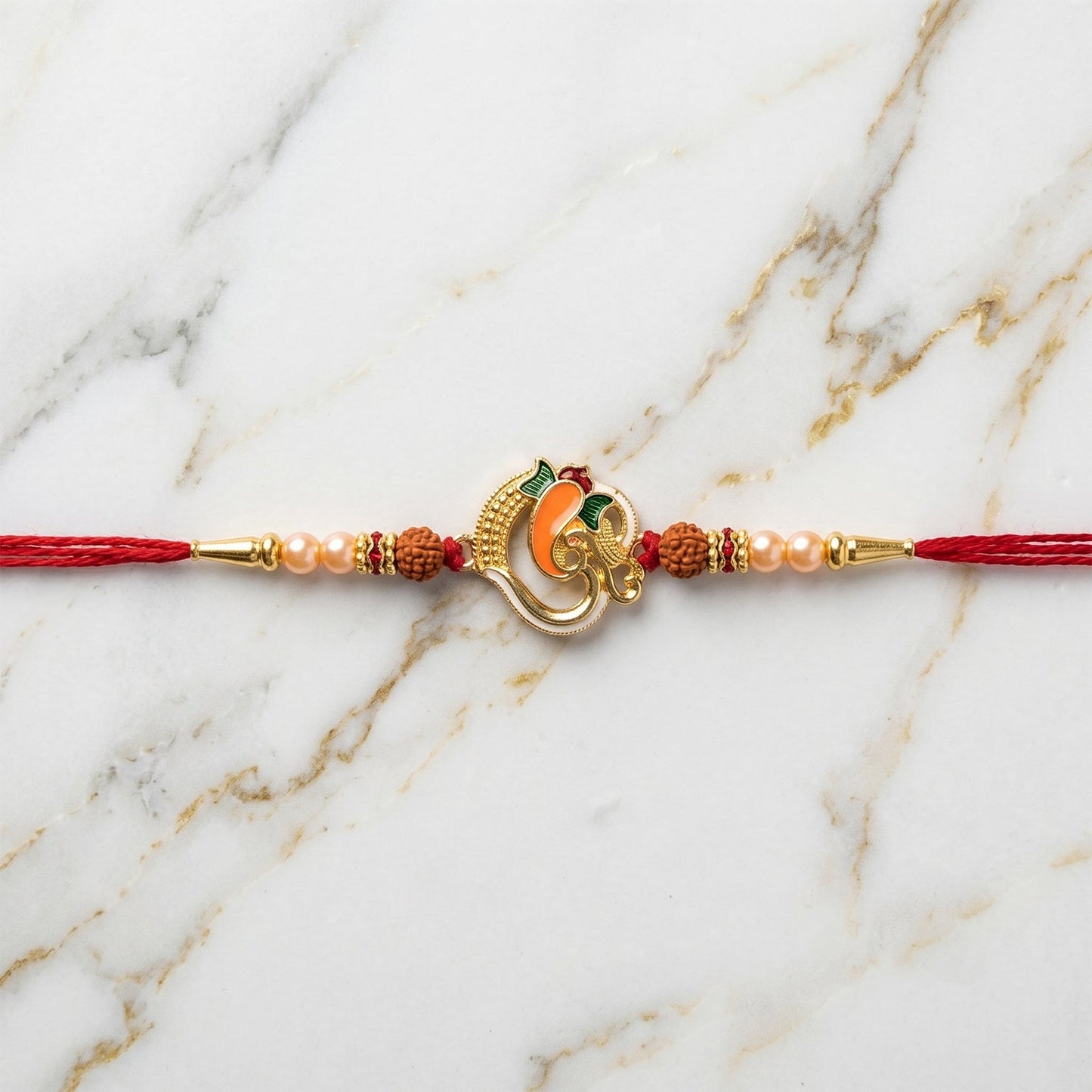 Ganesh motif Rakhi laid out on a decorative background