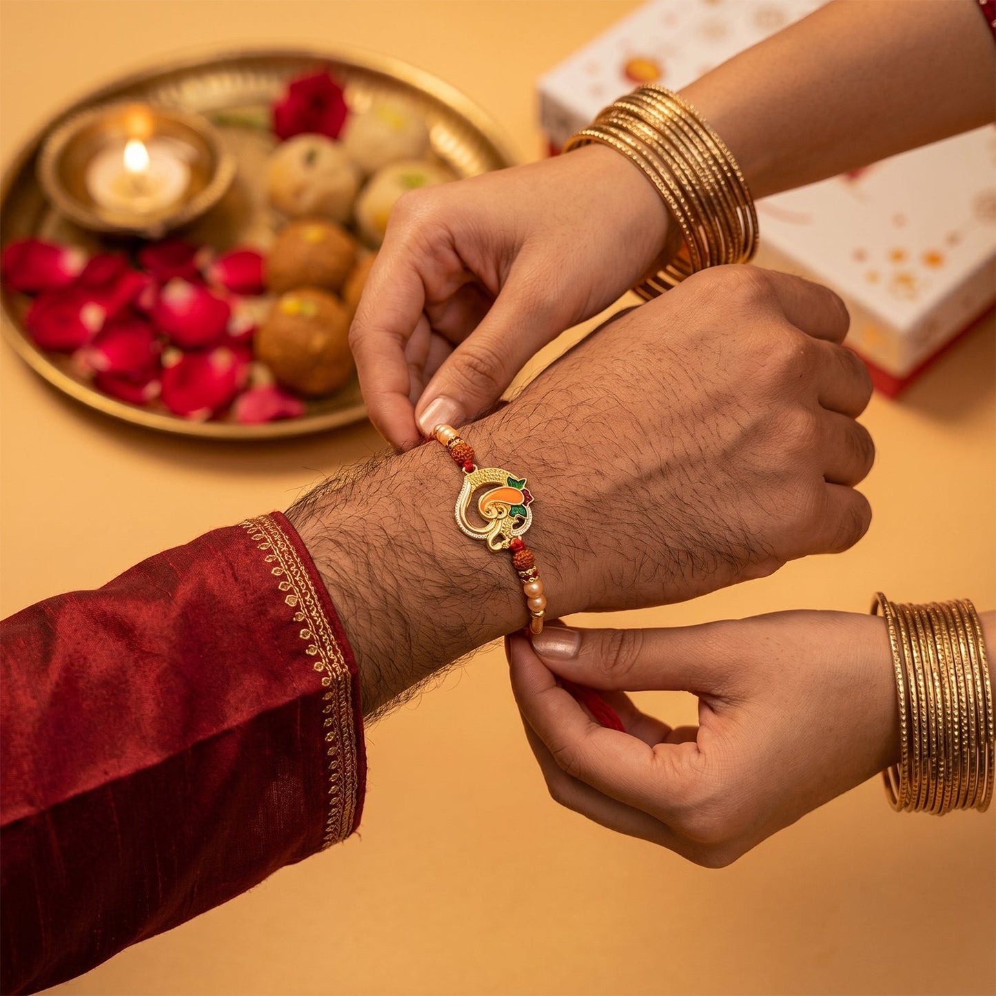 Rakhi showcasing Ganesh motif and Rudraksha beads with festive background