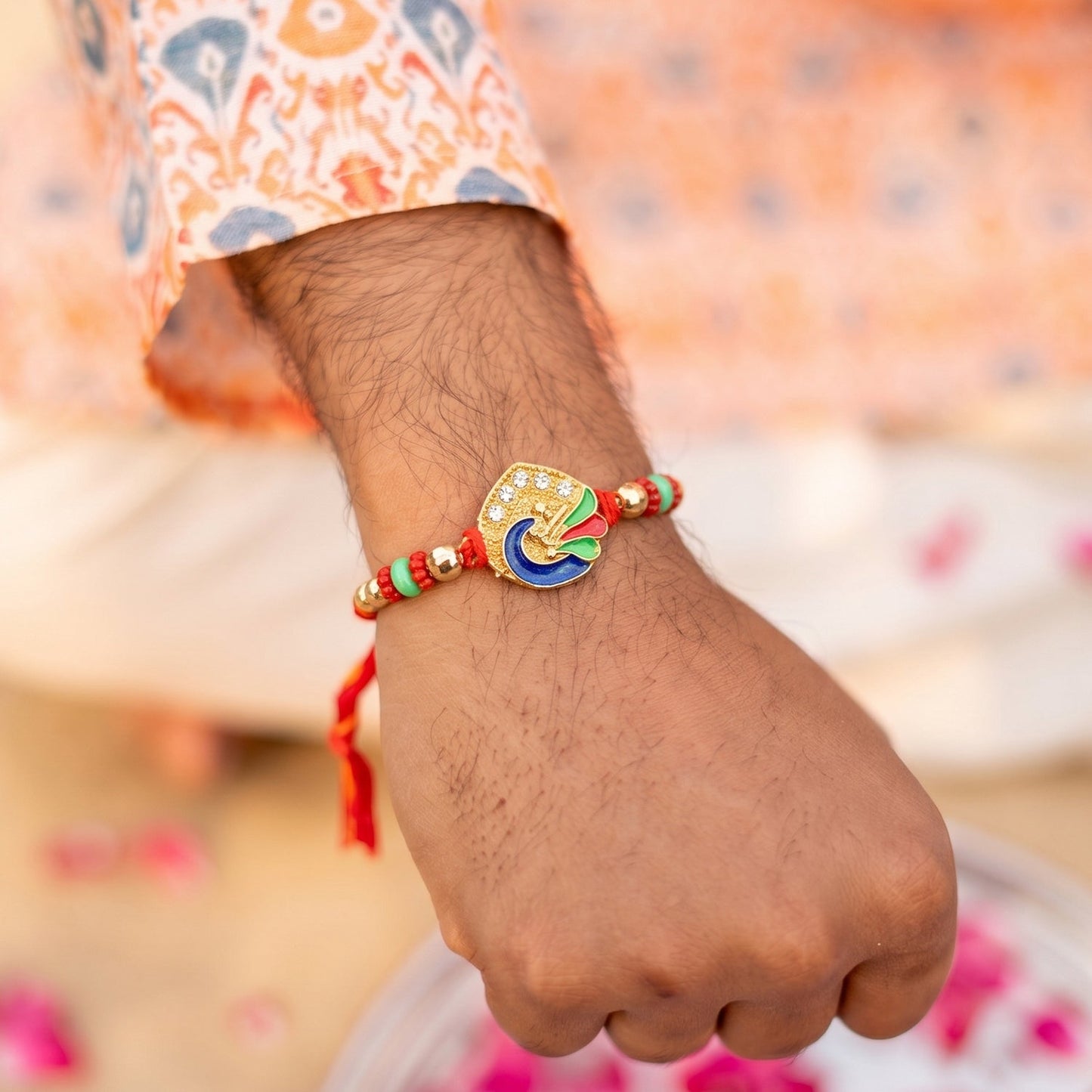 Close-up of peacock centerpiece on Rakhi with vibrant beads