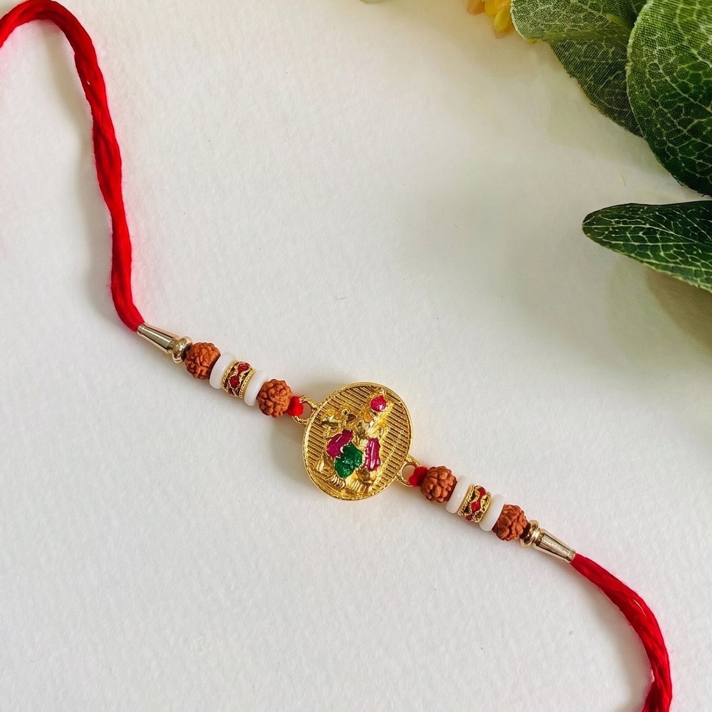 Side view of Lord Krishna Rakhi showcasing centerpiece