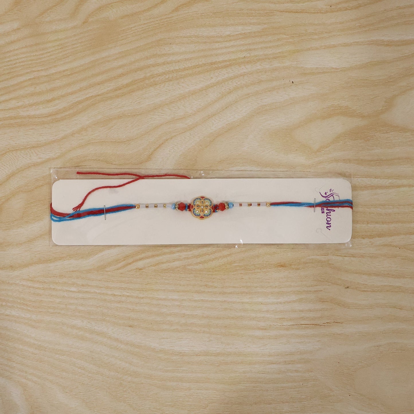 Multicolor floral Rakhi with soft thread displayed
