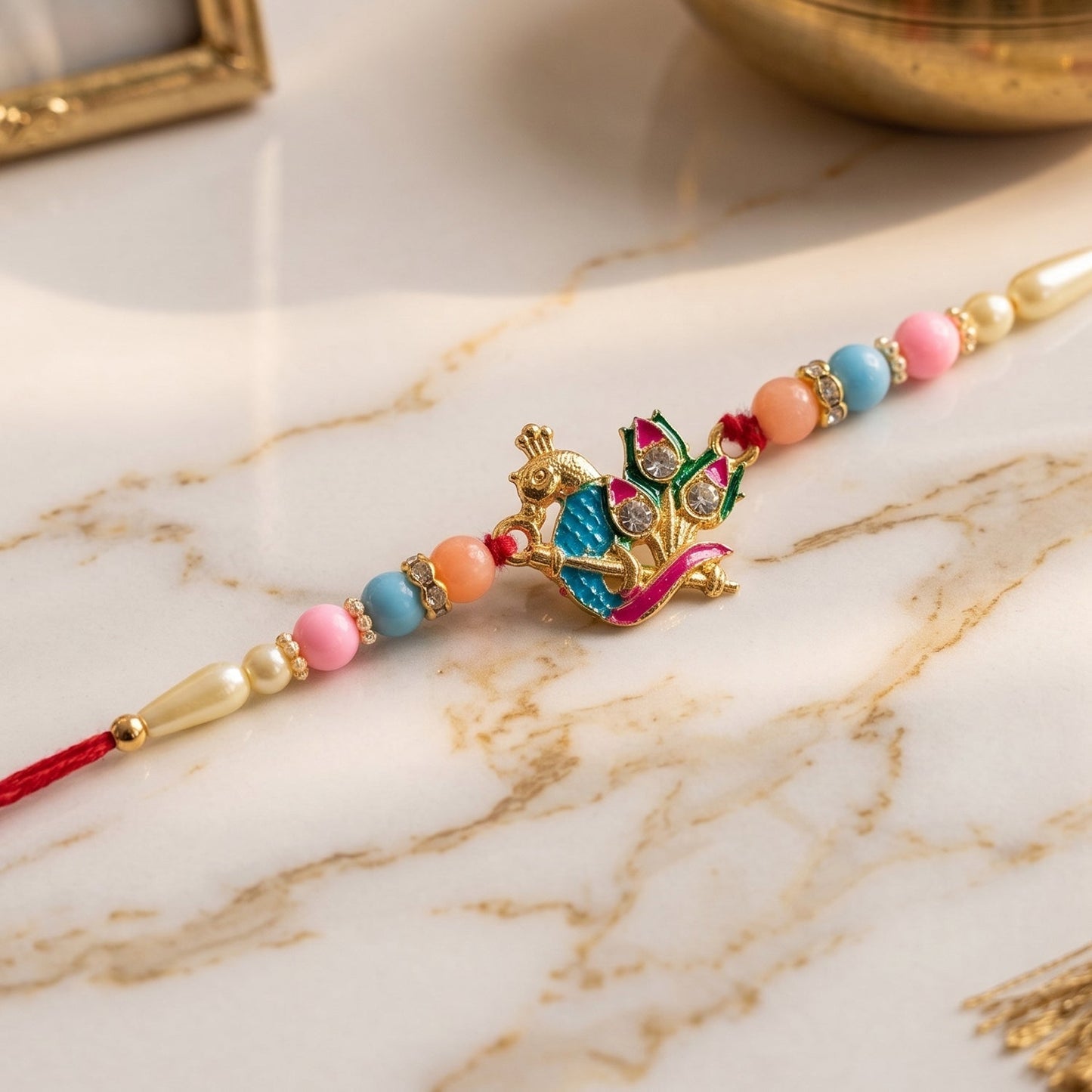 Hand holding Designer Peacock Rakhi, highlighting size