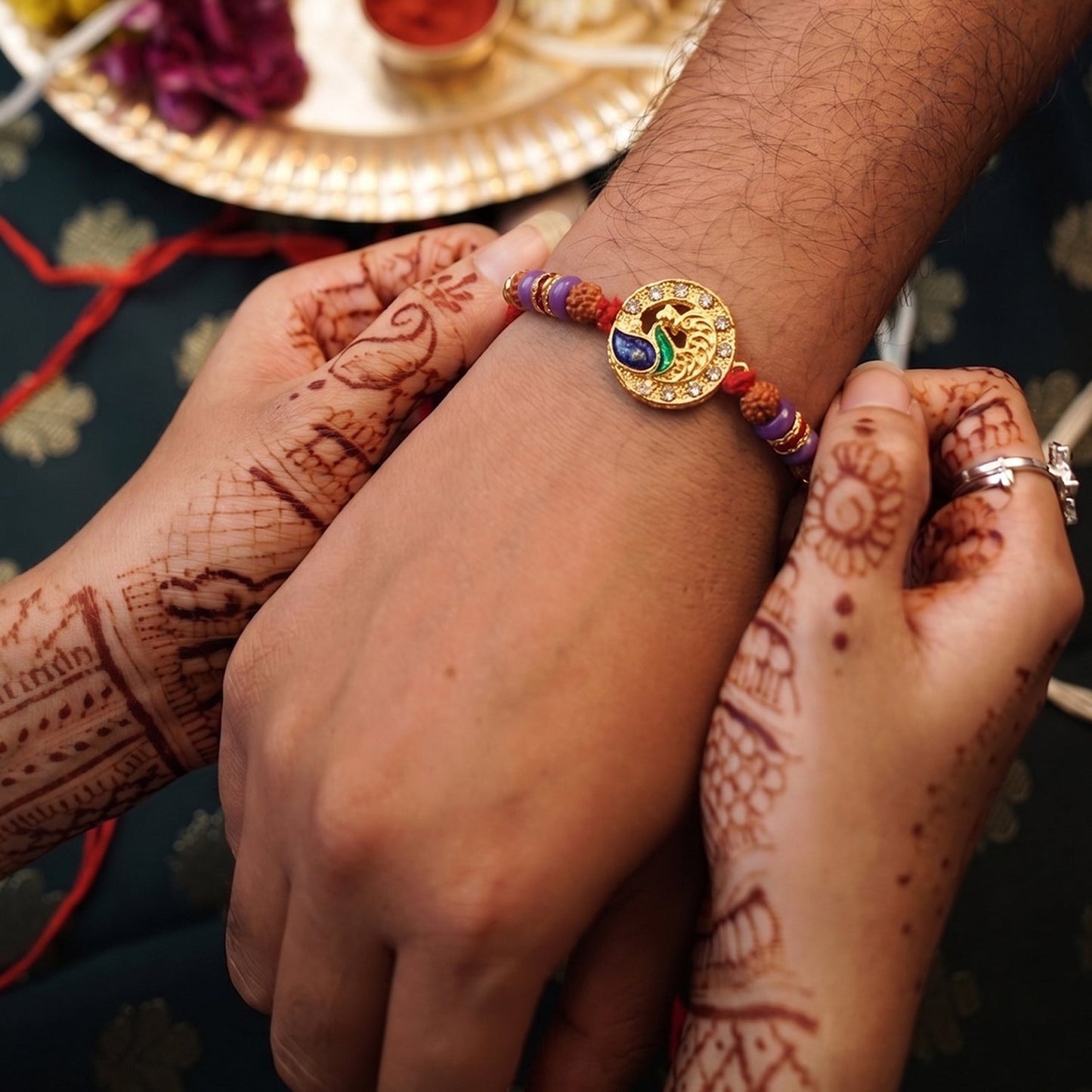 Peacock Design Rakhi displayed on a white background showing colorful beads