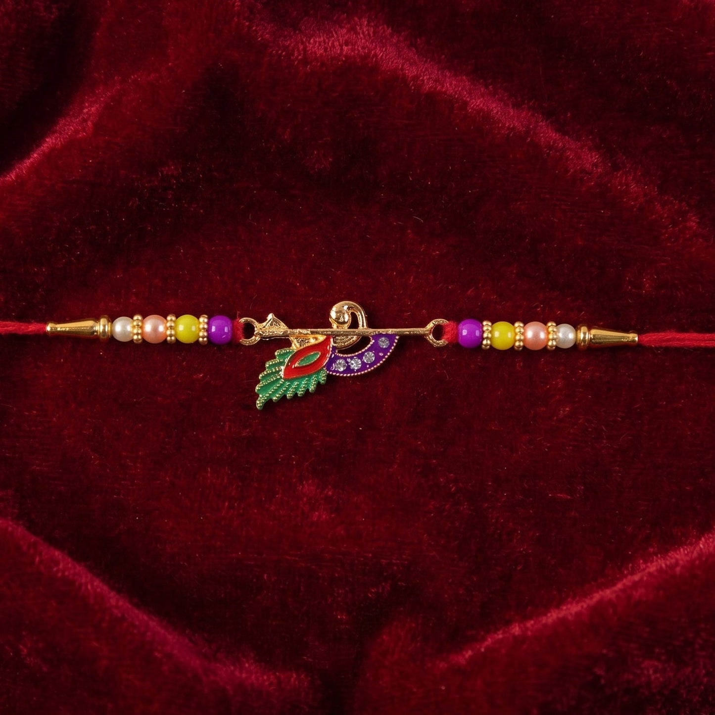 Flat lay of Peacock Feather Flute Rakhi showing centerpiece and beads