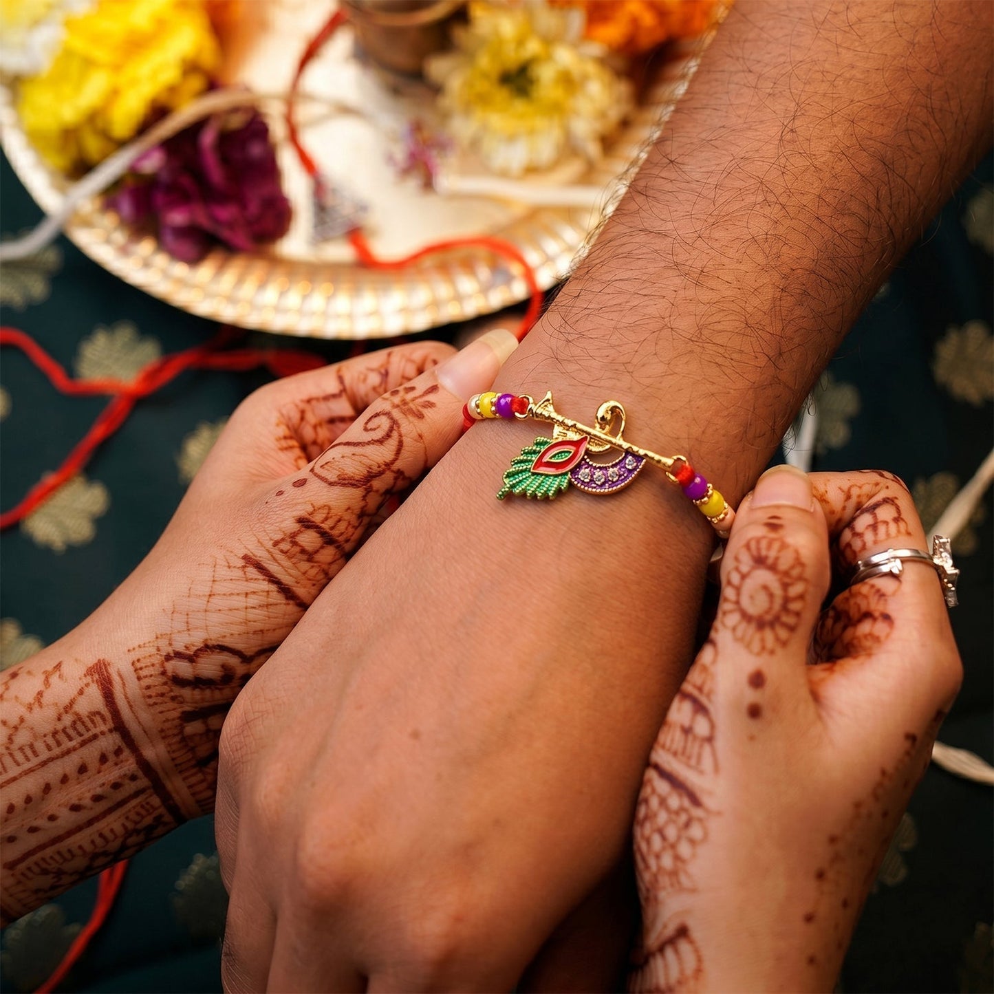 Close-up of Peacock Feather Flute Rakhi showing detailed beads