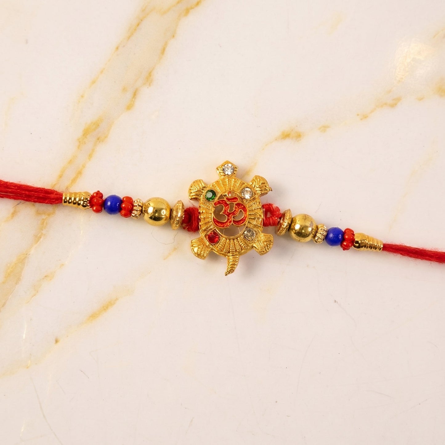Close-up of beadwork on Om Turtle Design Rakhi