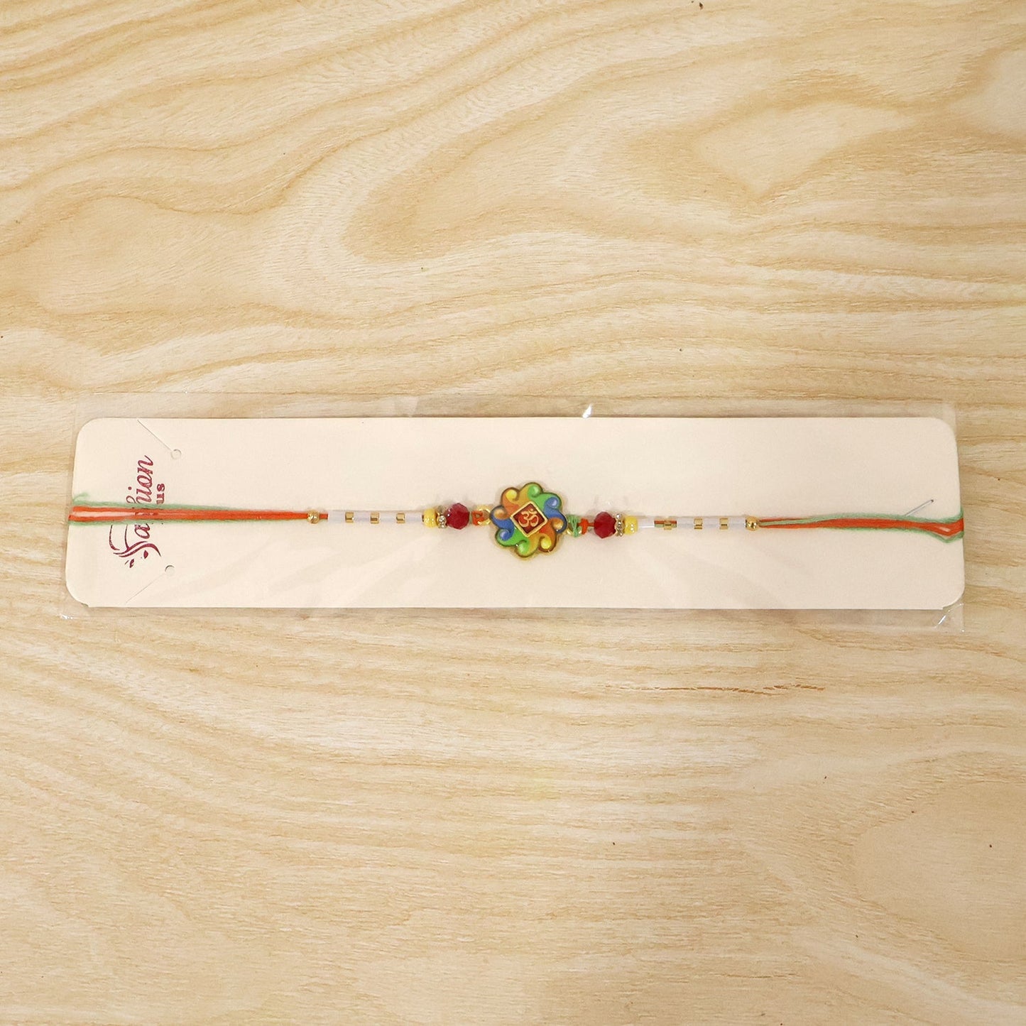 Full view of colorful Om Rakhi with beads and vibrant design