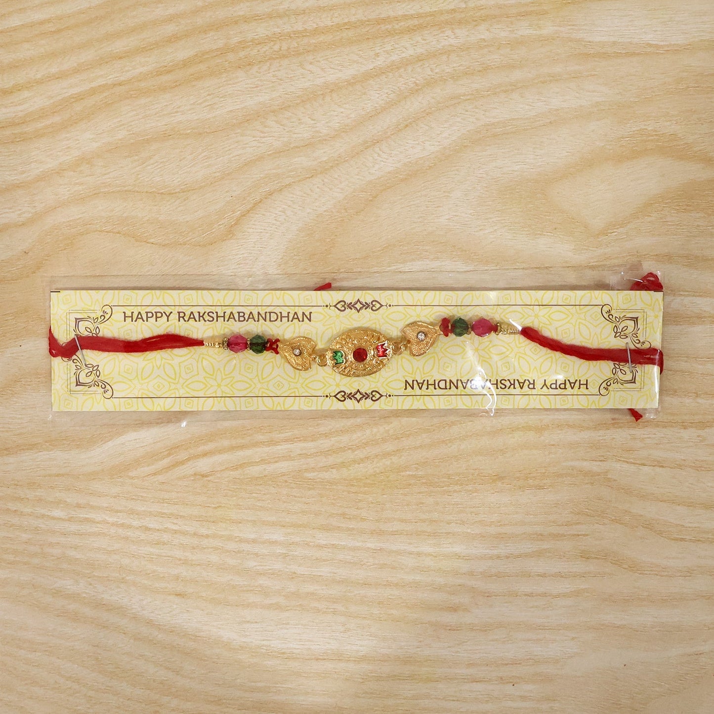 Full-length view of gold stone rakhi with beads