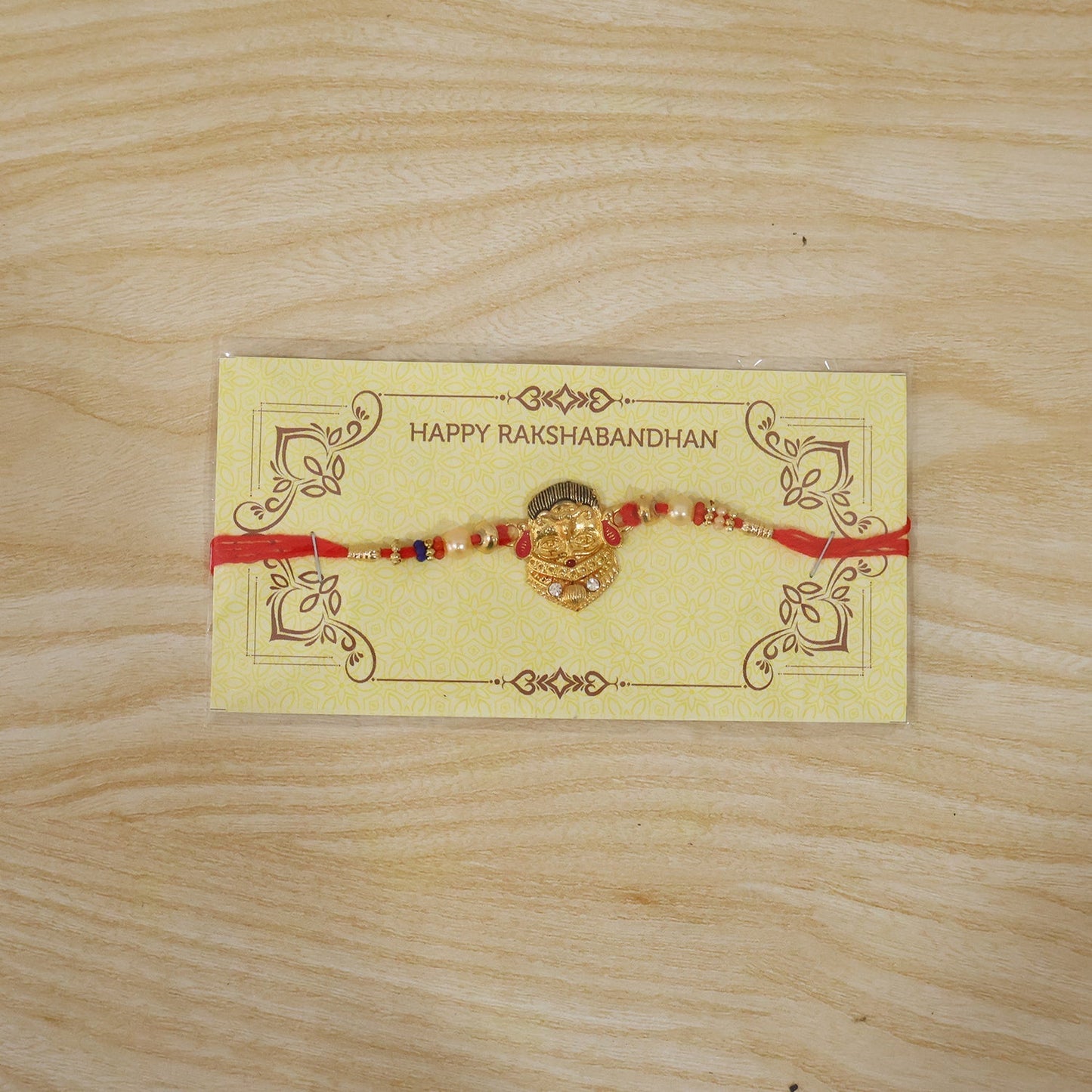 Fully spread decorative rakhi with beads and red thread