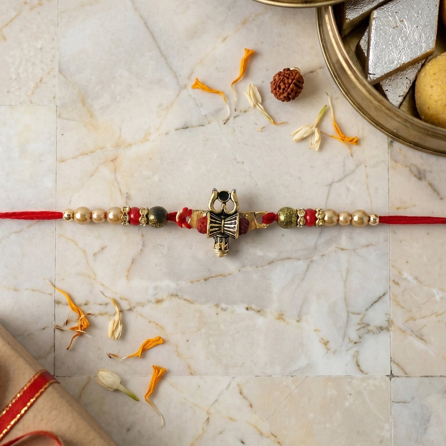 Side angle view of Damru Trishul Rakhi with beads