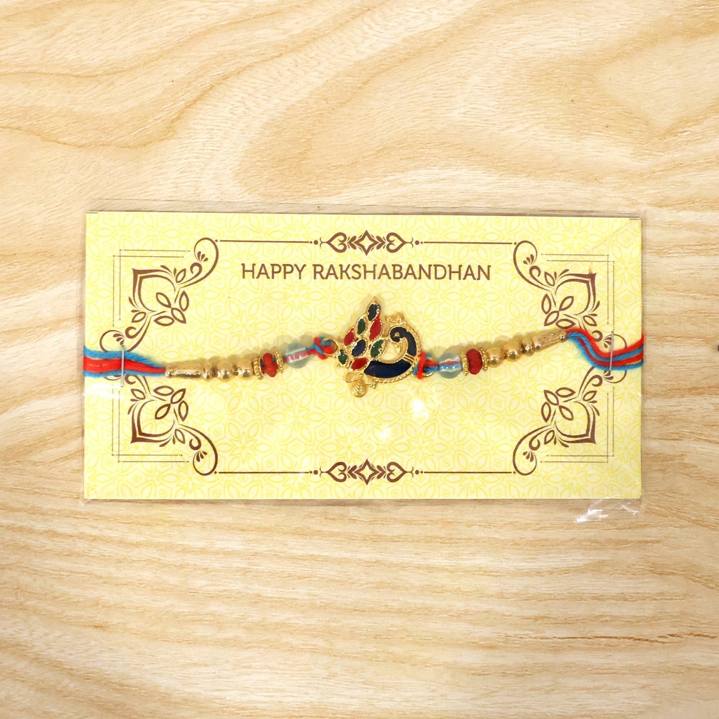Closeup of peacock design with beads on rakhi