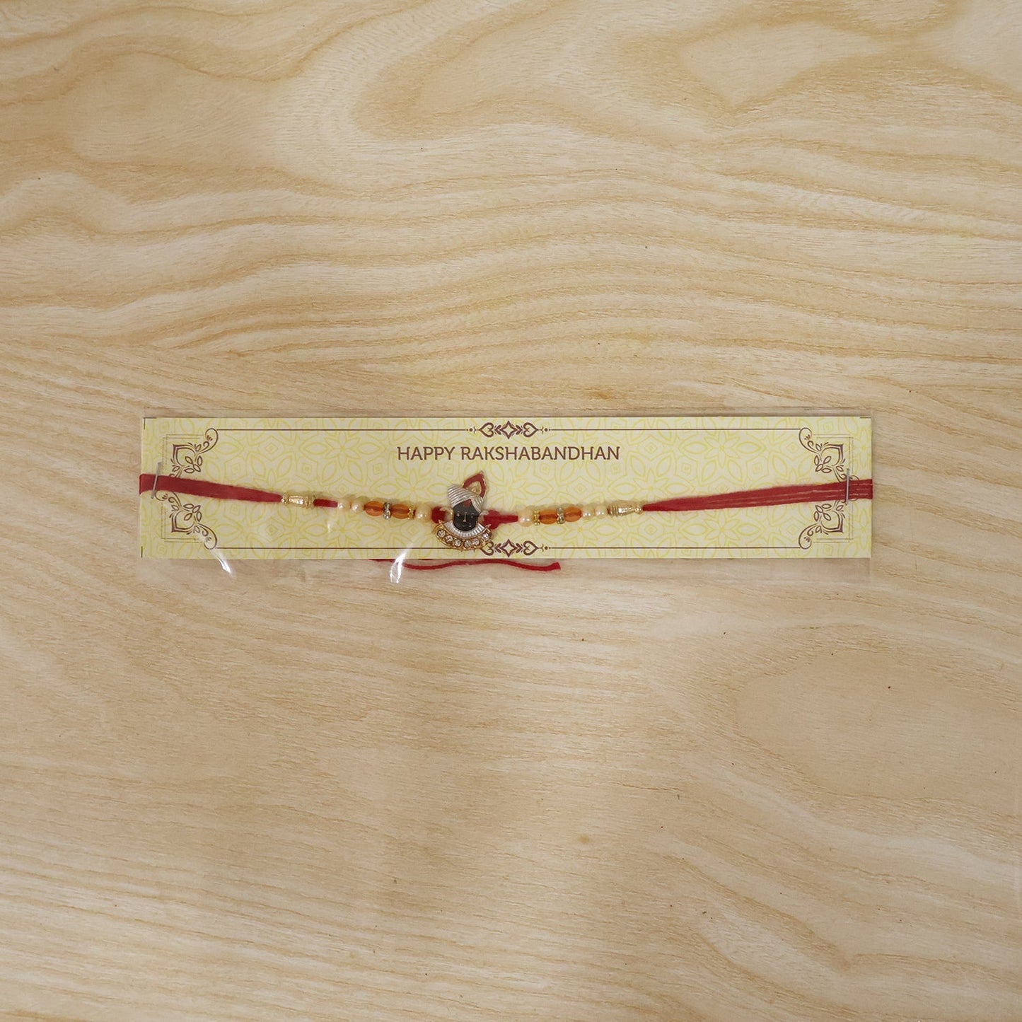 Traditional styled Shrinathji Rakhi with red thread