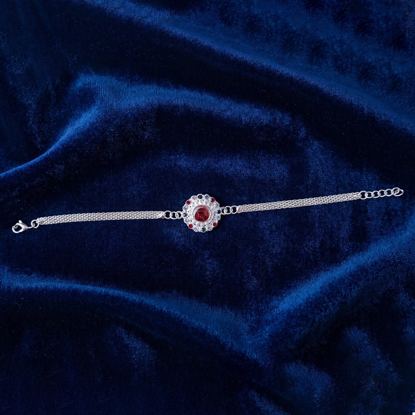 Stylish Silver Stone Chain Rakhi with a prominent red stone accent.