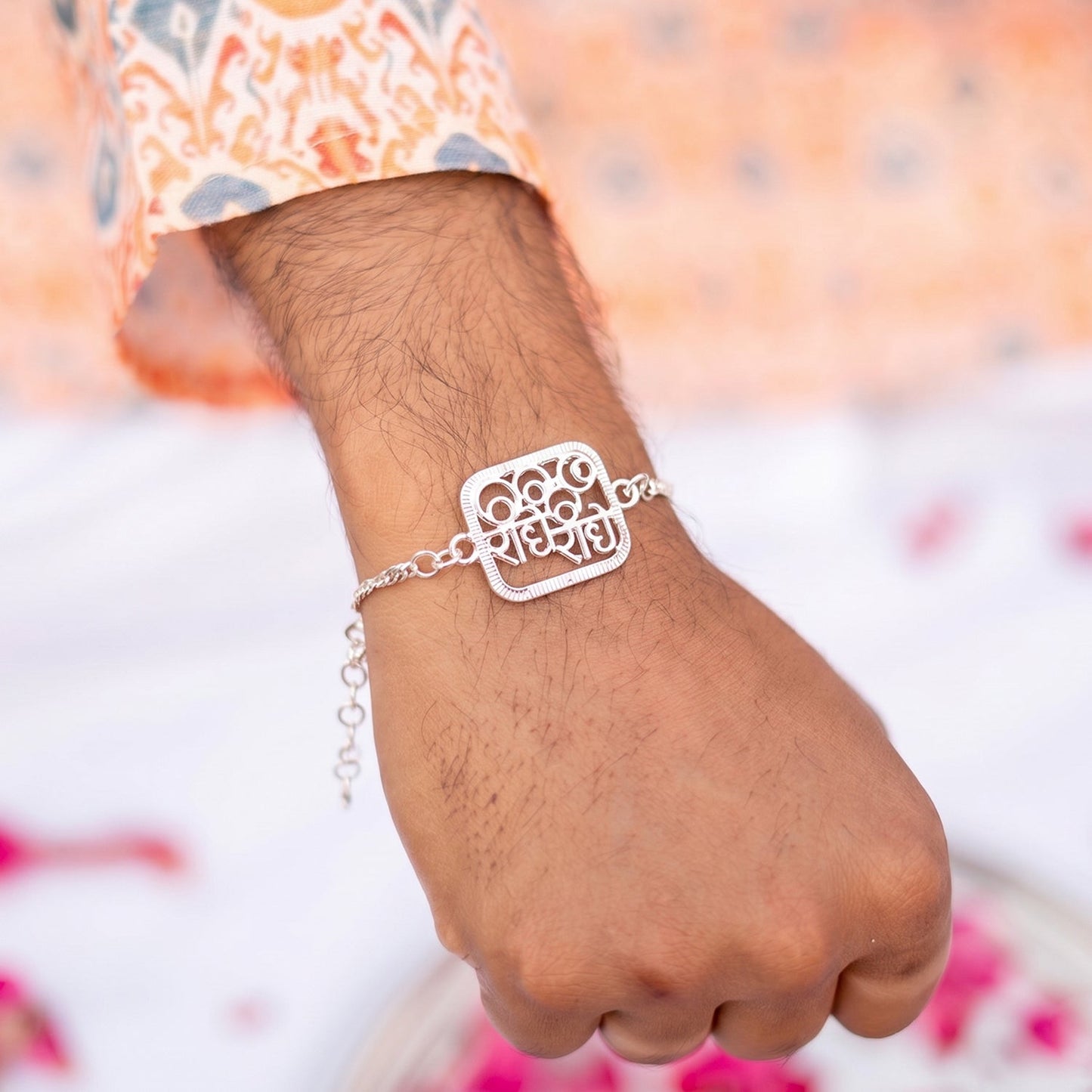 Close-up of Silver Radhe Radhe Rakhi showing fine details and finish.