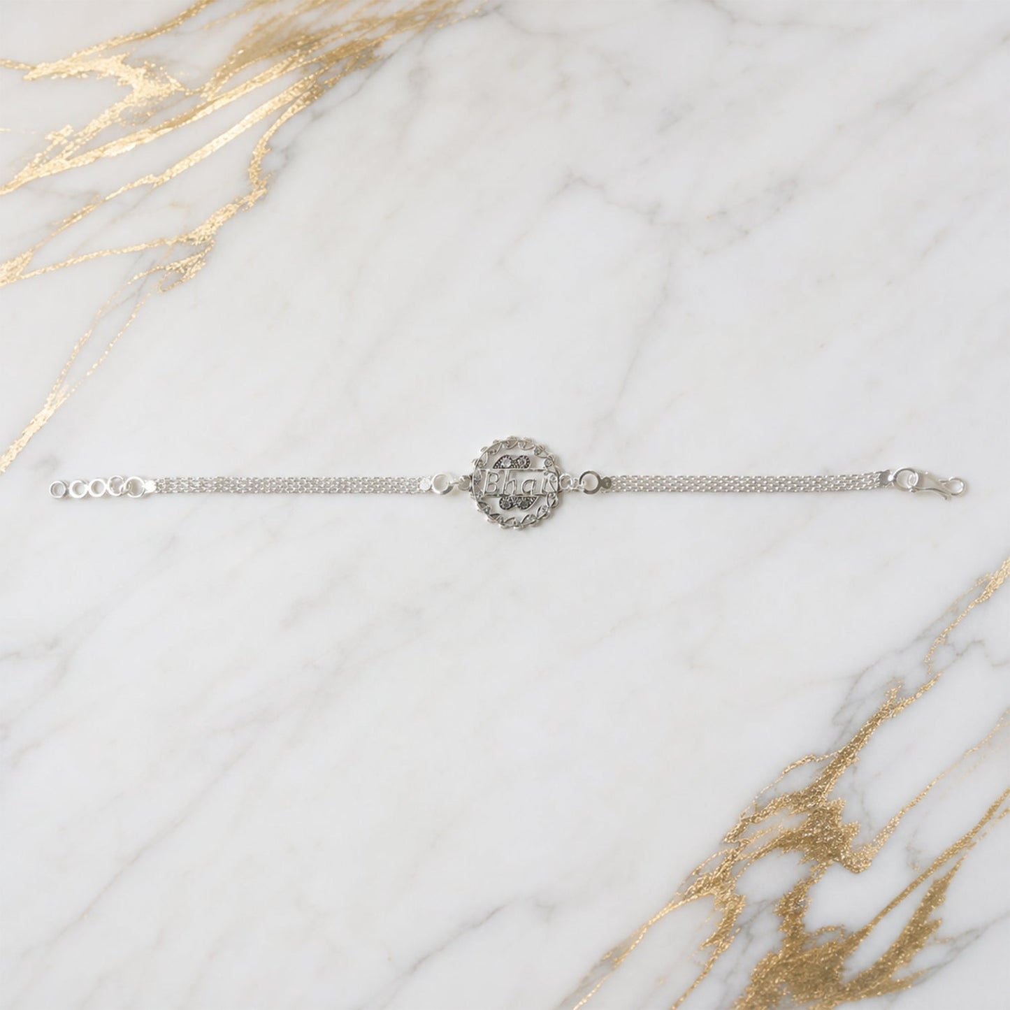 Another view of the Silver Bhai Chain Rakhi with its unique round designer element.