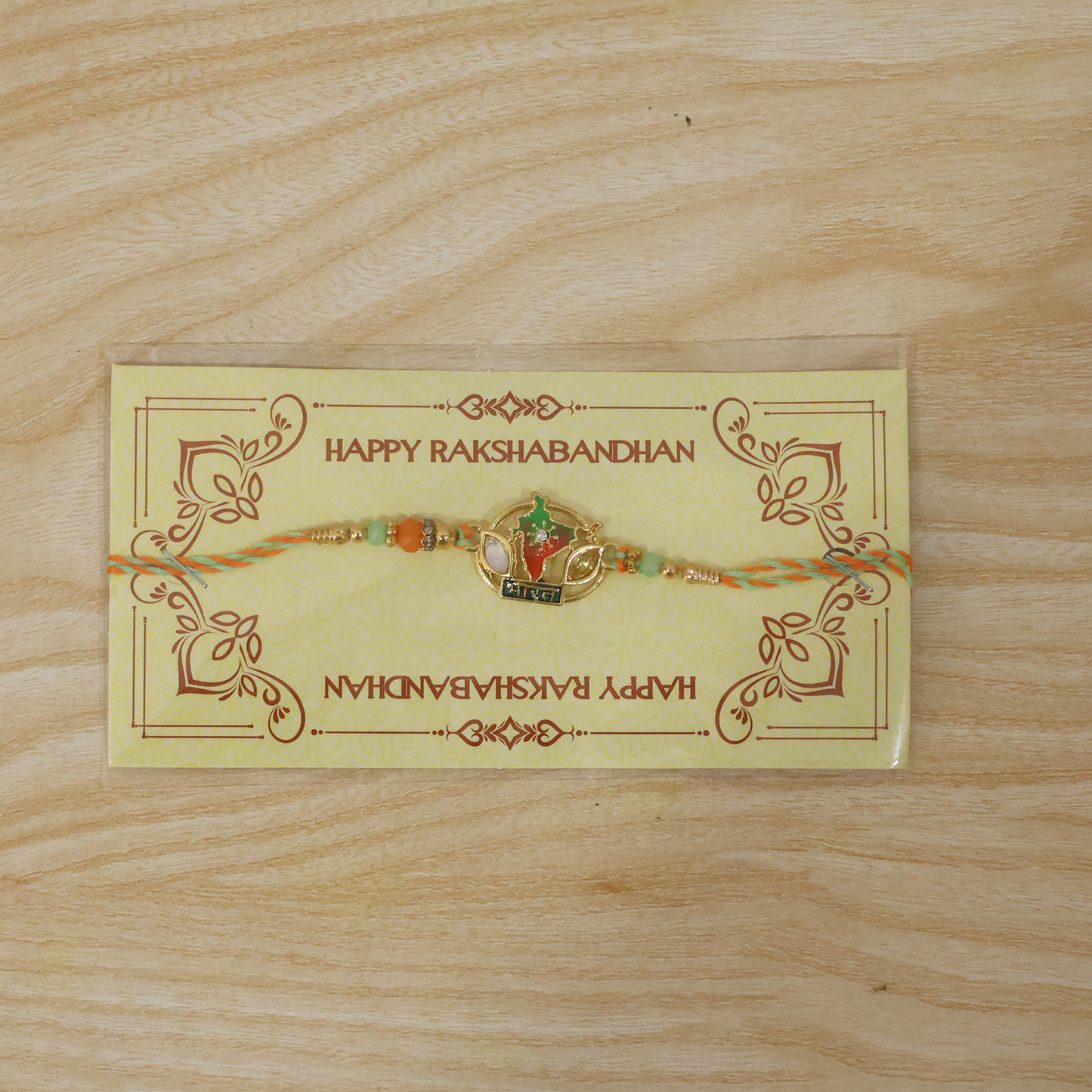Close-up of Bharat India Map charm with beads on Rakhi