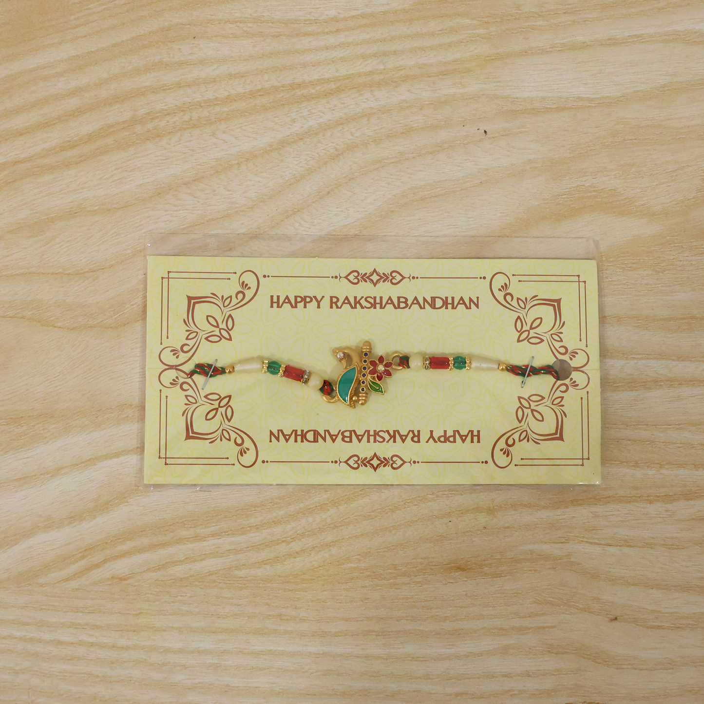 Peacock floral rakhi tied on thread with beads