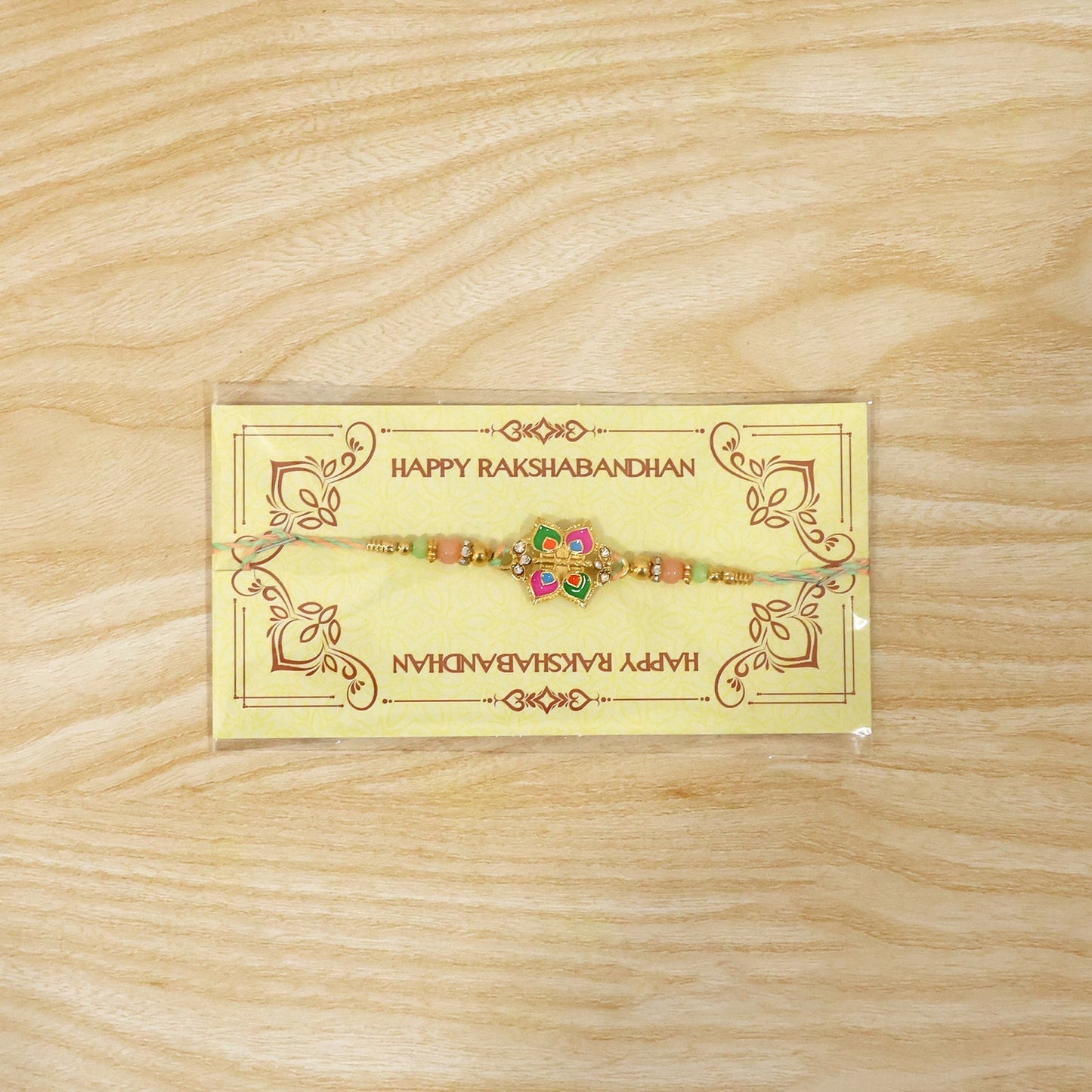 Full view of stylish floral charm rakhi for brother