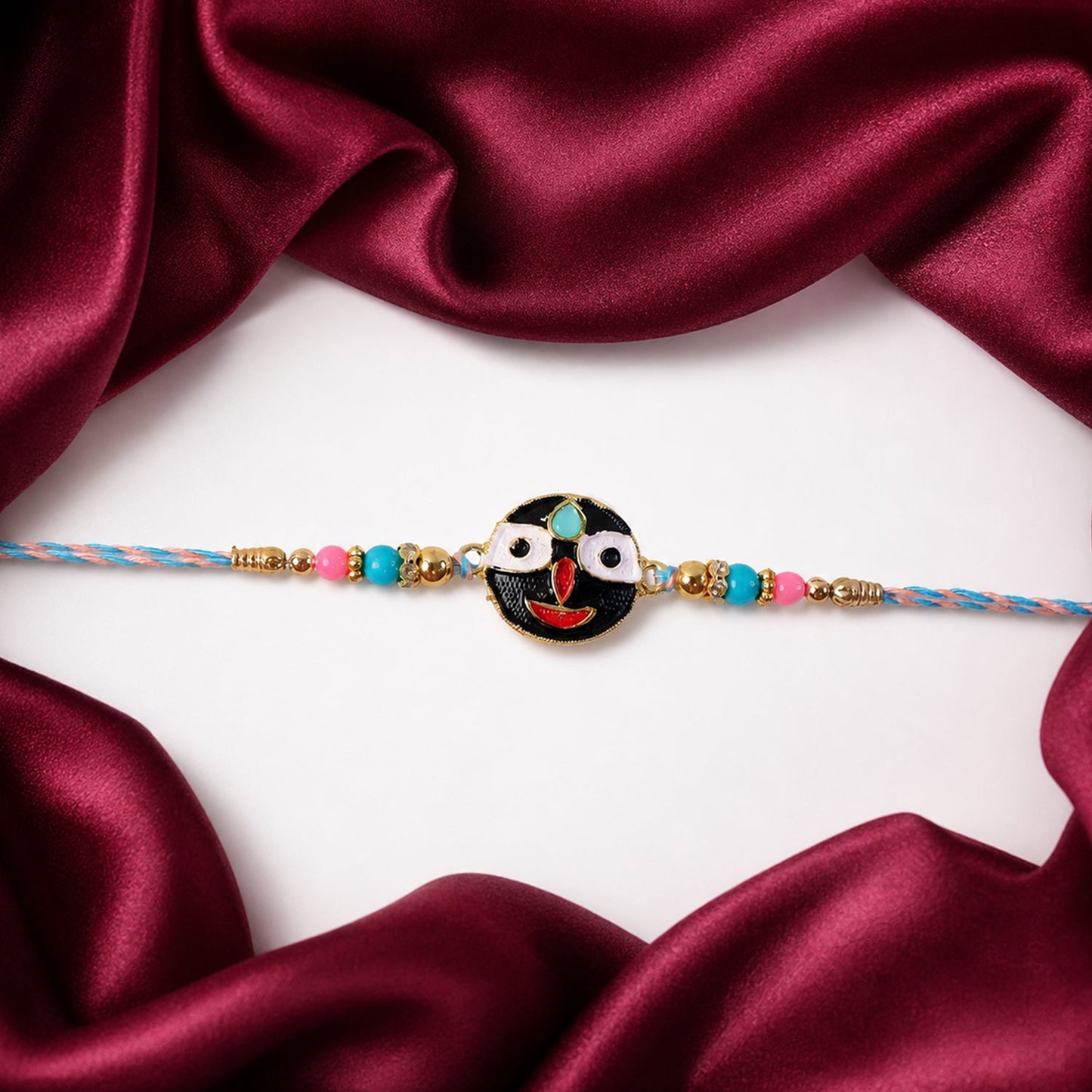 Designer rakhi featuring deity face and beads tied on thread