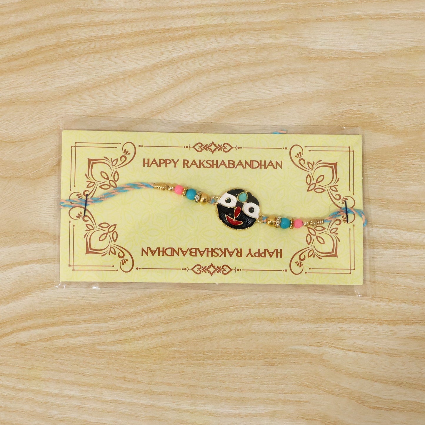 Festive colorful rakhi with deity face charm and beads