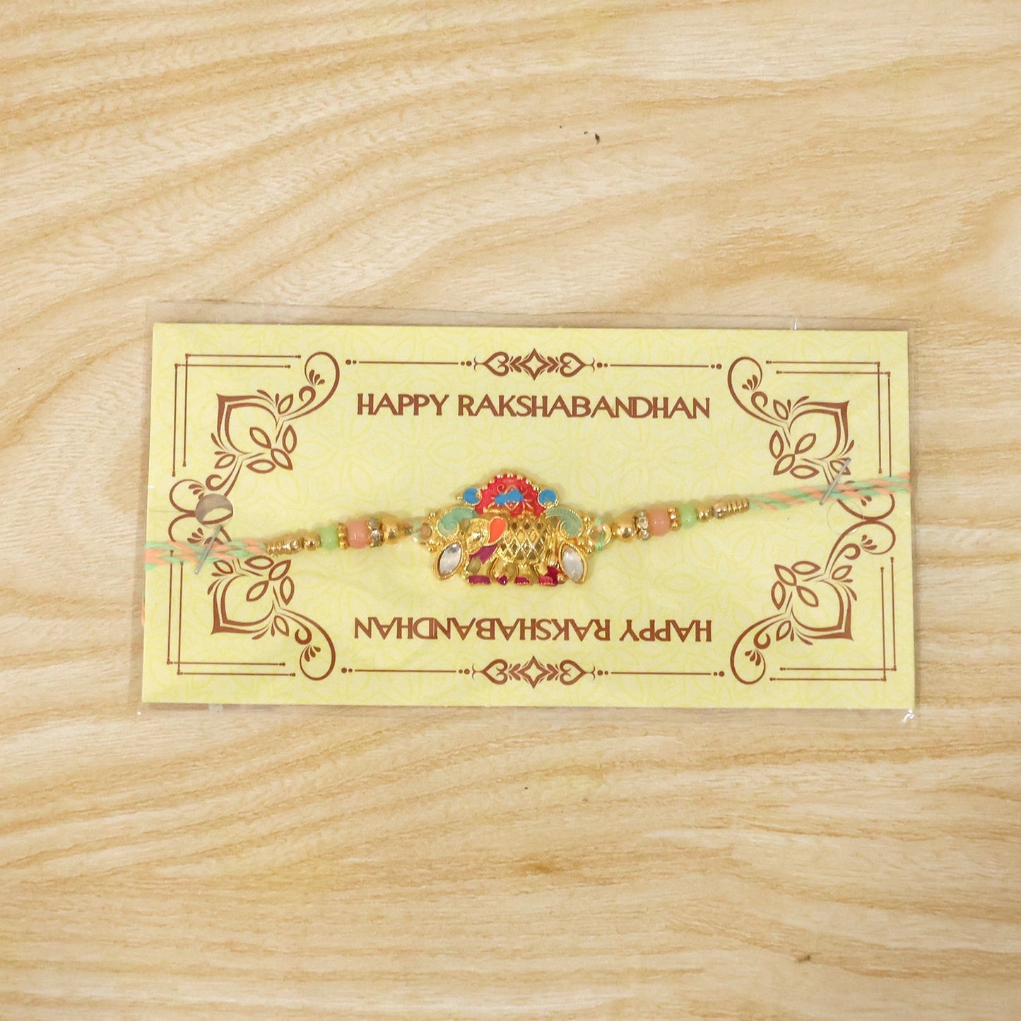 Stylish rakhi featuring elephant charm and multicolor beads