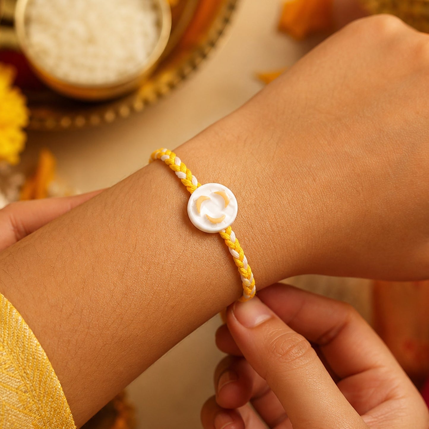 Close-up of the White Round Charm on the Rakhi showing its detailed design
