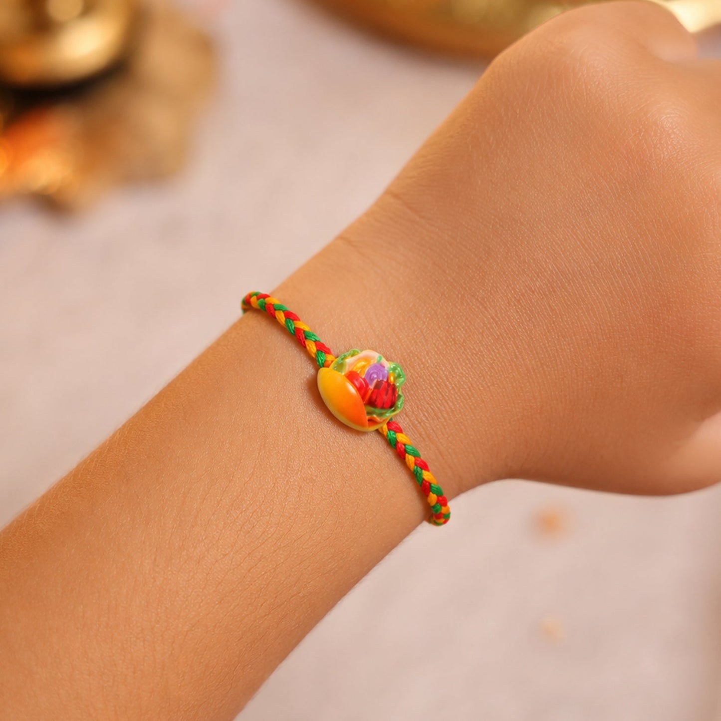 Close-up view of the intricate fruit design on the Dori Rakhi.