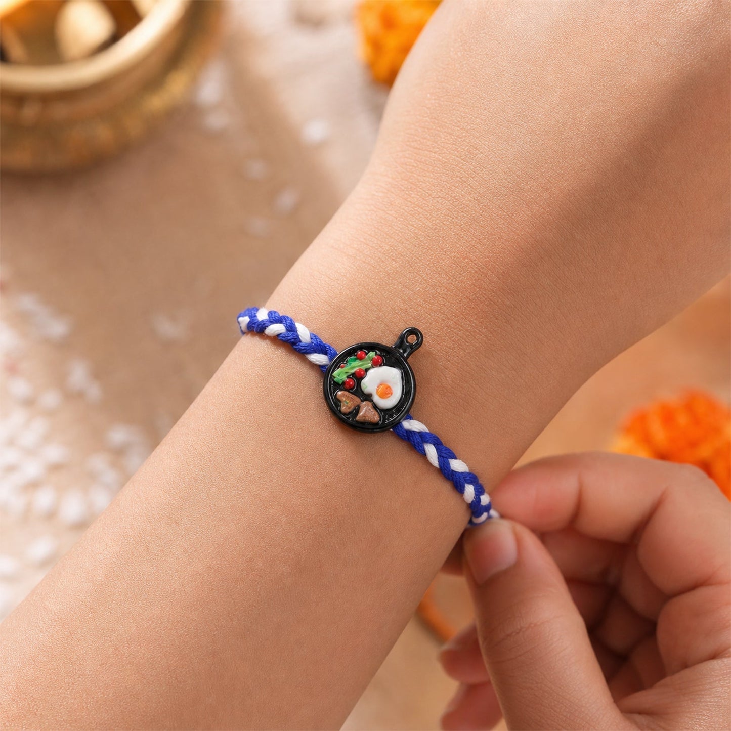 Side angle view of mini frying pan Rakhi, stylish and lightweight