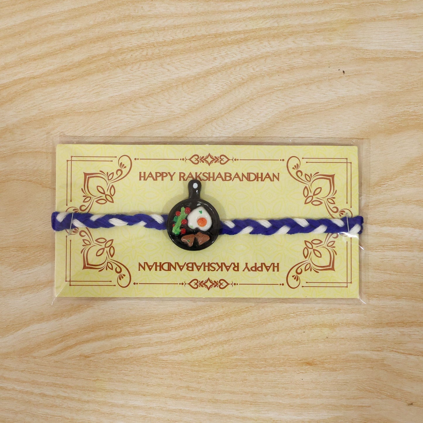 Festive look of mini frying pan Rakhi, ideal for Raksha Bandhan celebration