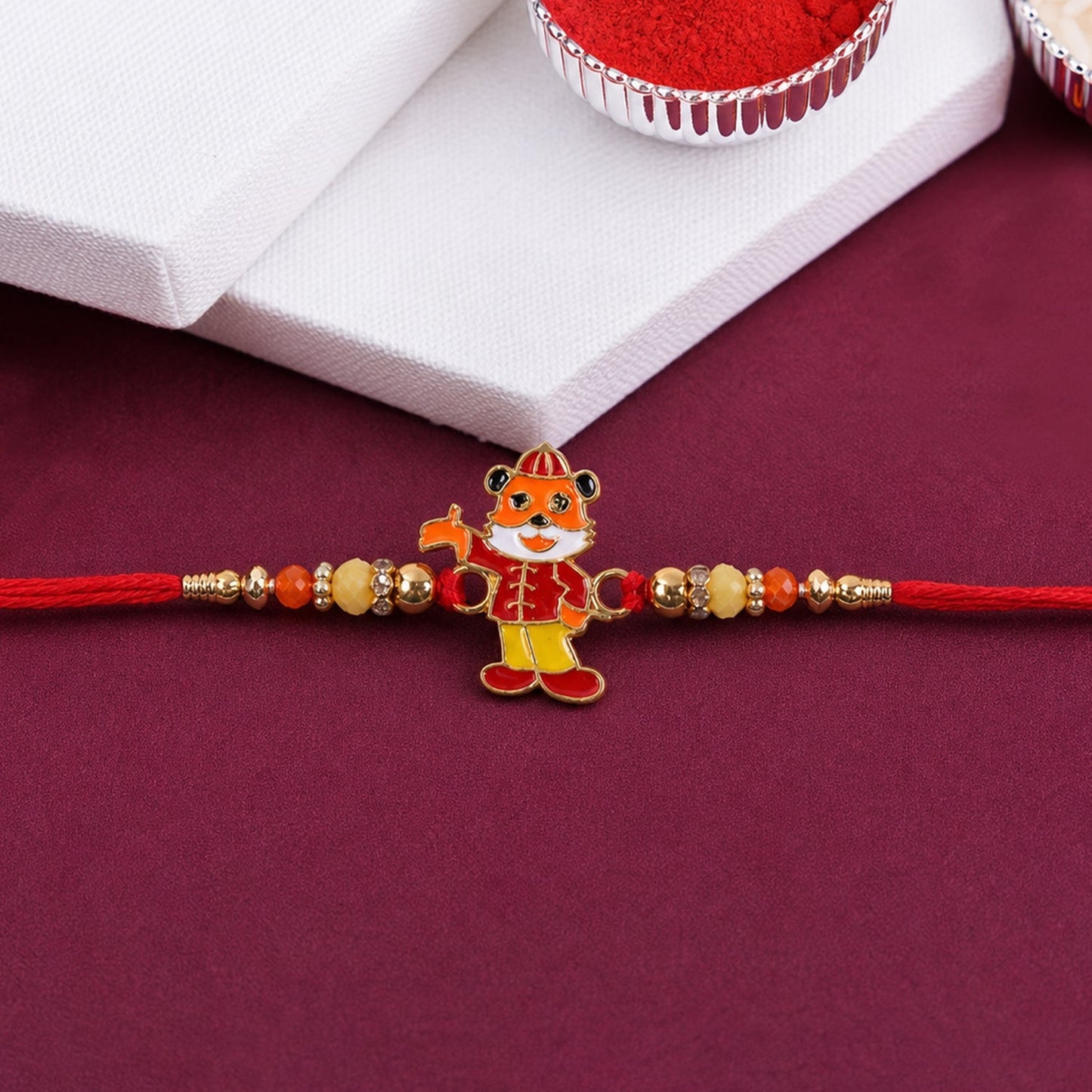 Side view of stylish rakhi showing detailed charm and thread craftsmanship