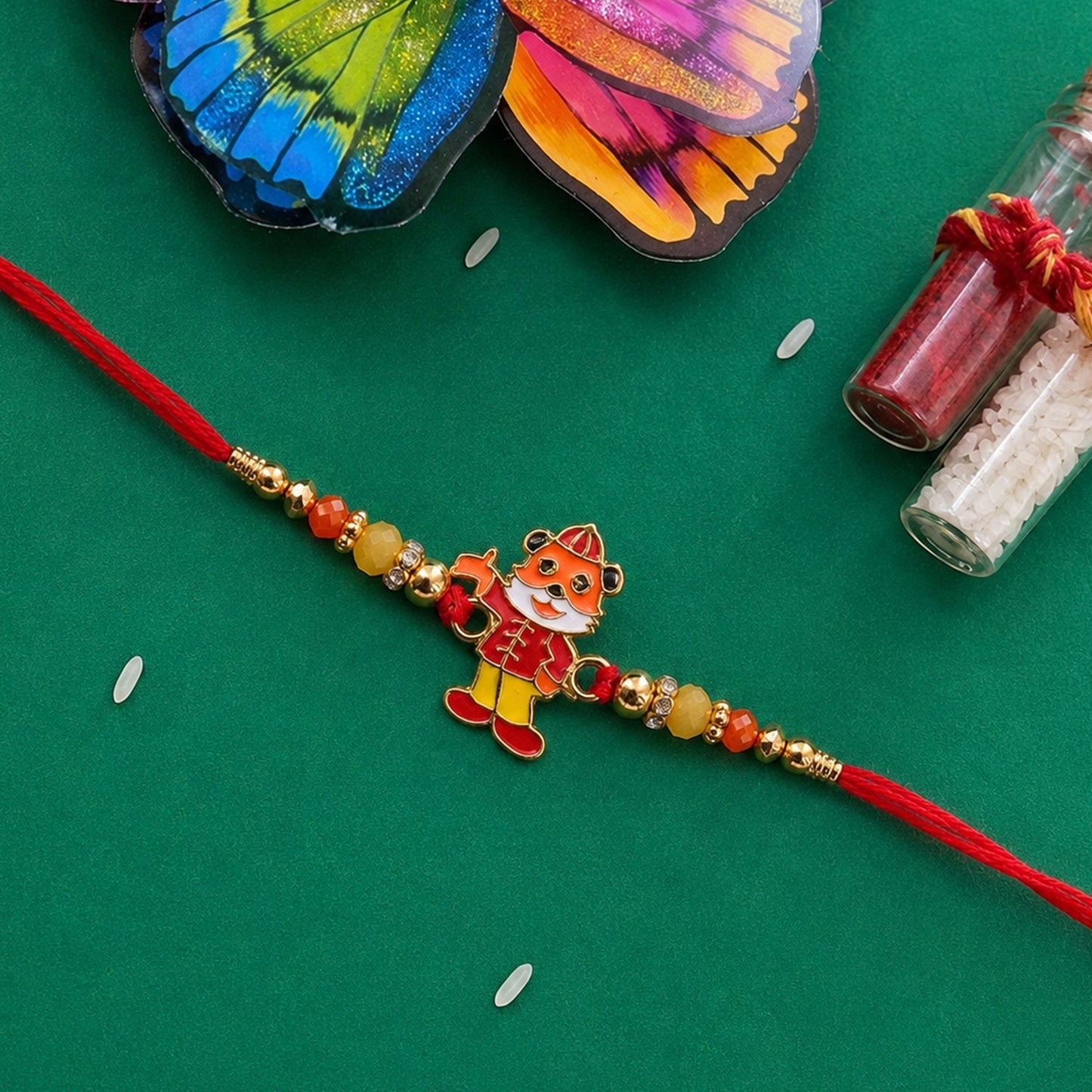Brightly colored designer rakhi tied on wrist for Raksha Bandhan