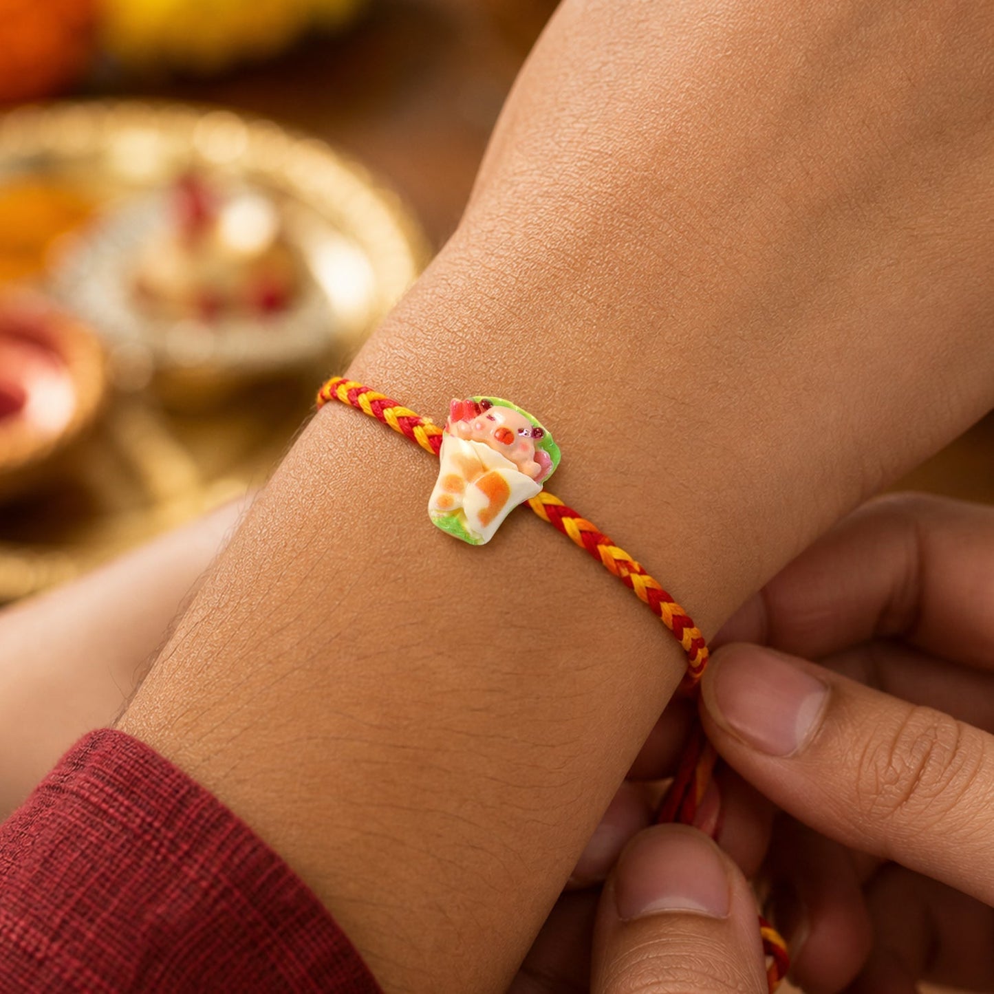 Colorful designer Rakhi with vibrant dori for Raksha Bandhan