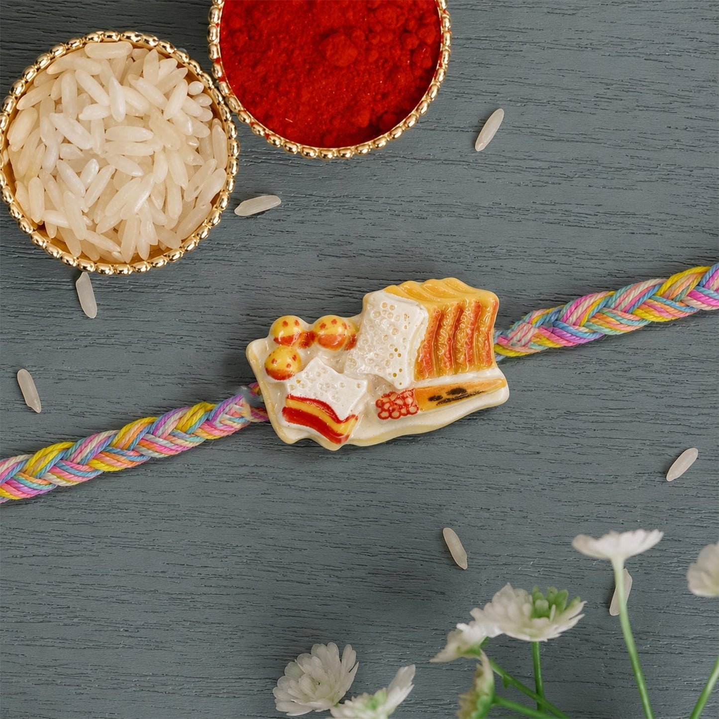 Traditional dori rakhi with a decorative charm for sibling celebration