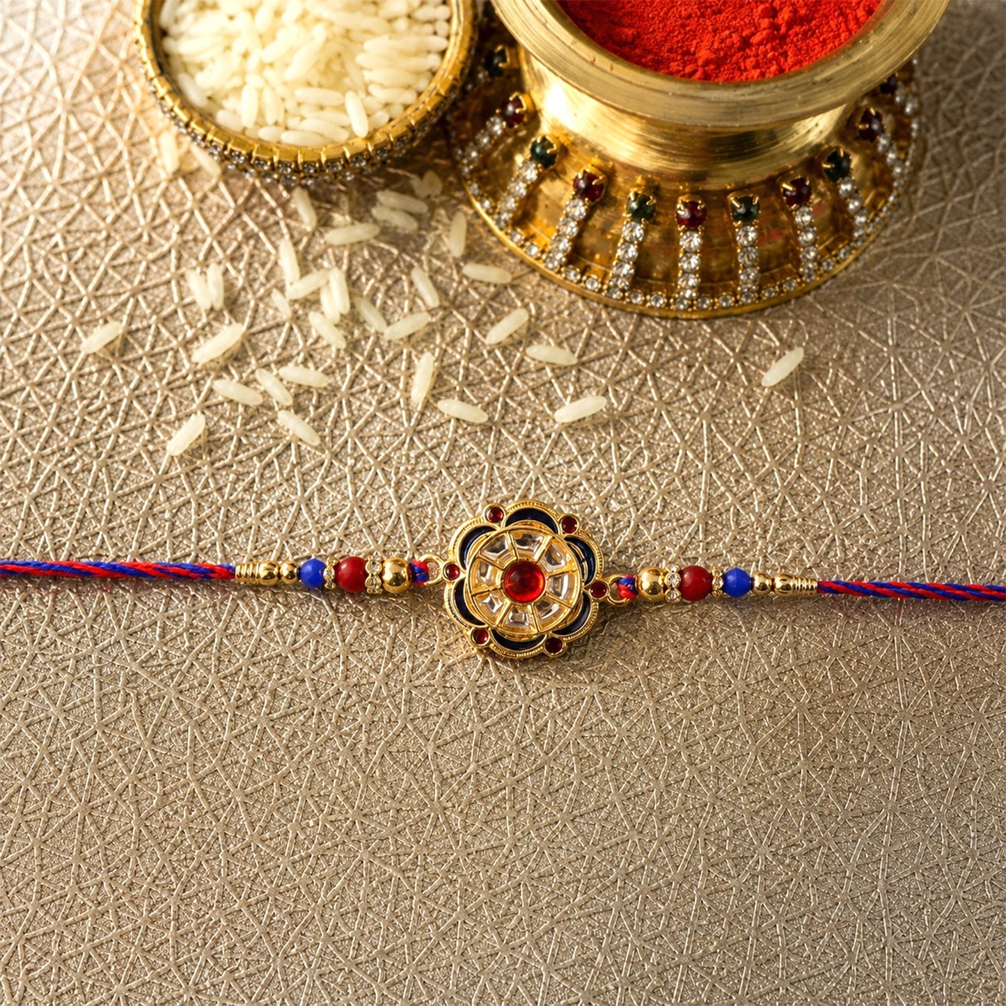 Flower motif rakhi displayed with beads and charm
