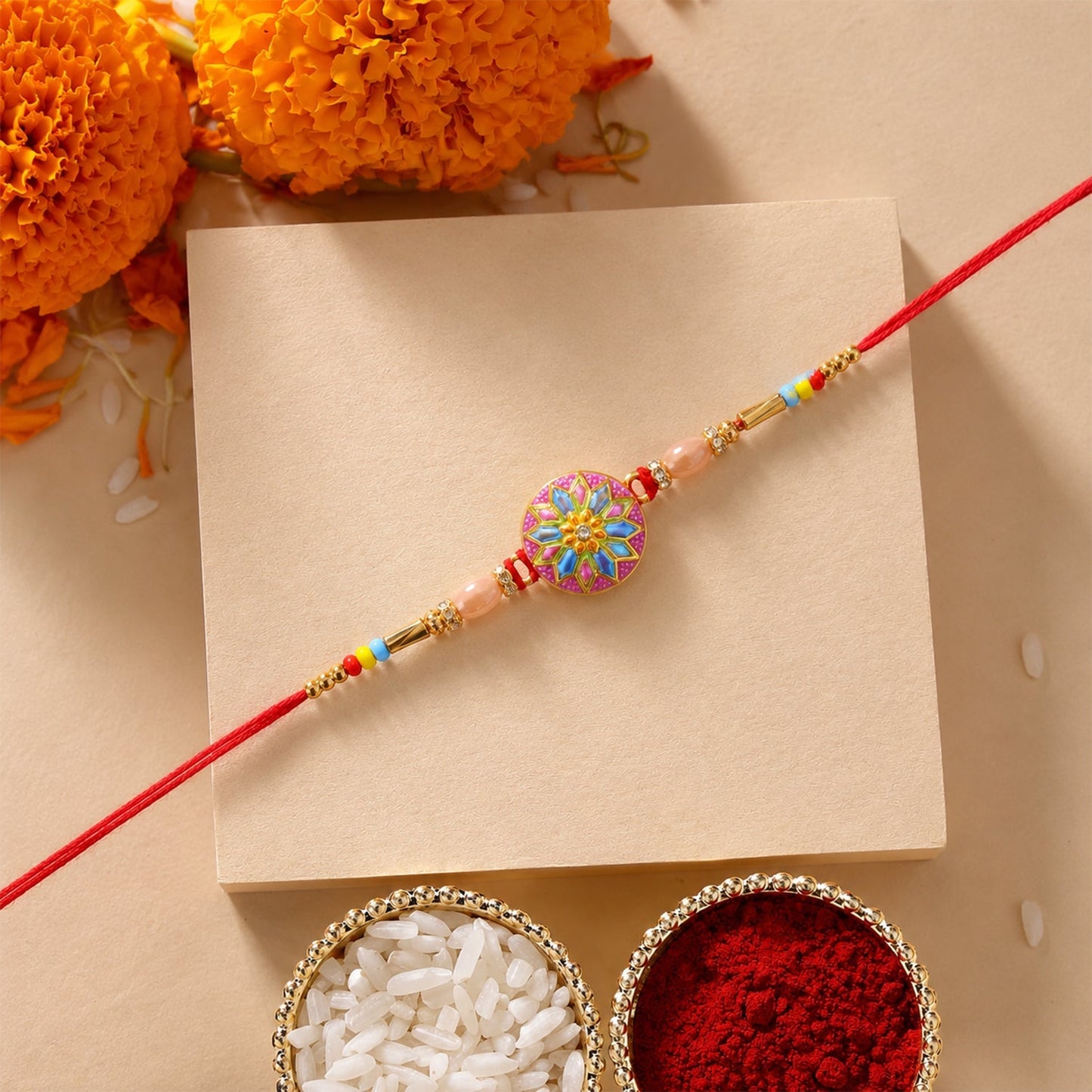 Close up of vibrant meenakari charm on rakhi with beads