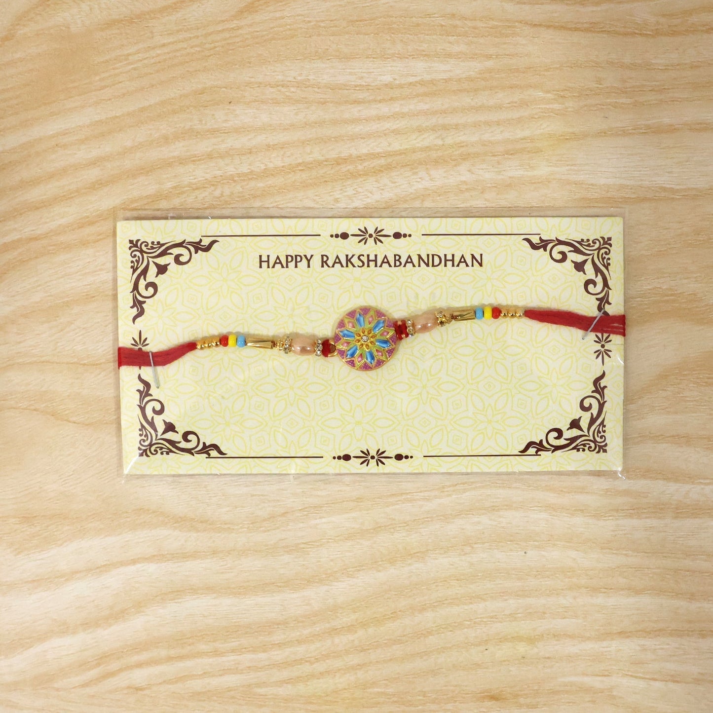 Elegant designer rakhi highlighting meenakari charm and beads