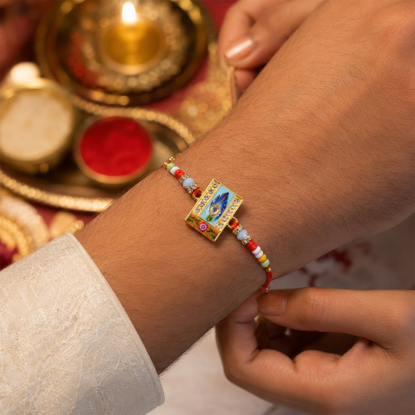 Designer Mor Pankh Square Kundan Rakhi with beads from an angled view