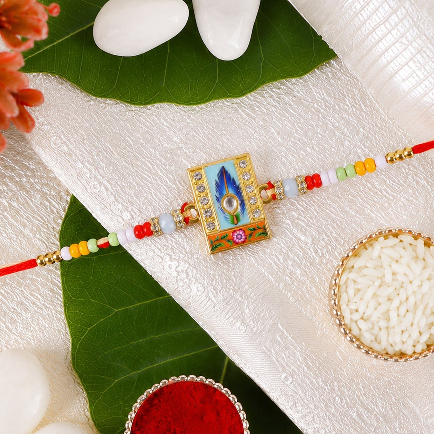 Elegant Mor Pankh Square Kundan Charm Rakhi tied with thread