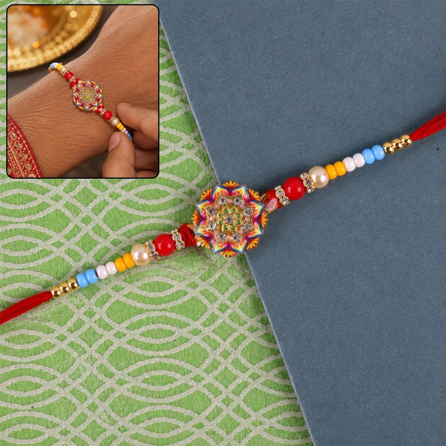 Front view of Rangoli Mandala stone charm Rakhi with pearl beads