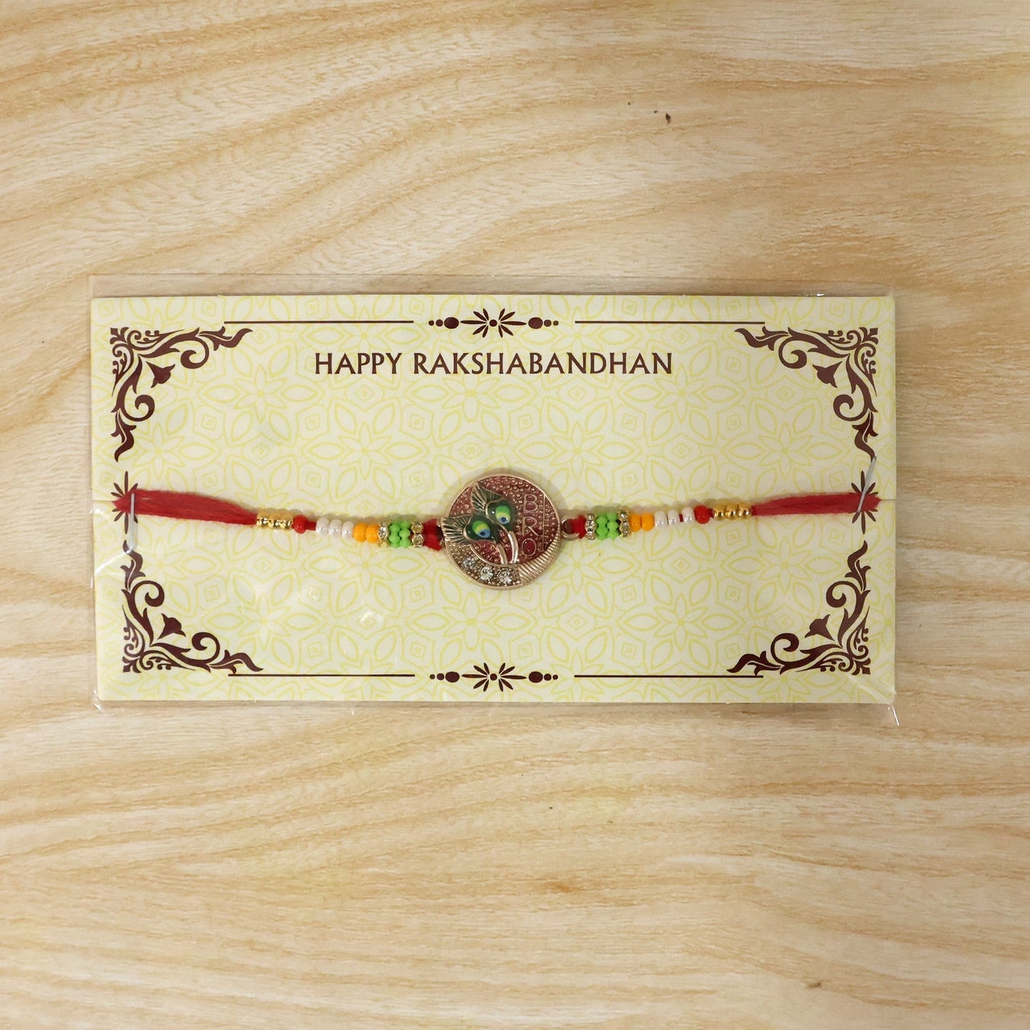 Colorful beads and peacock feather charm rakhi detail