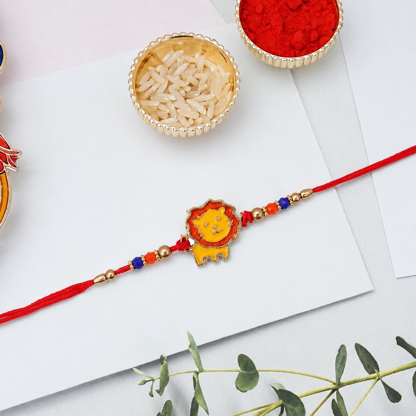 Top view of lion bead rakhi with thread design
