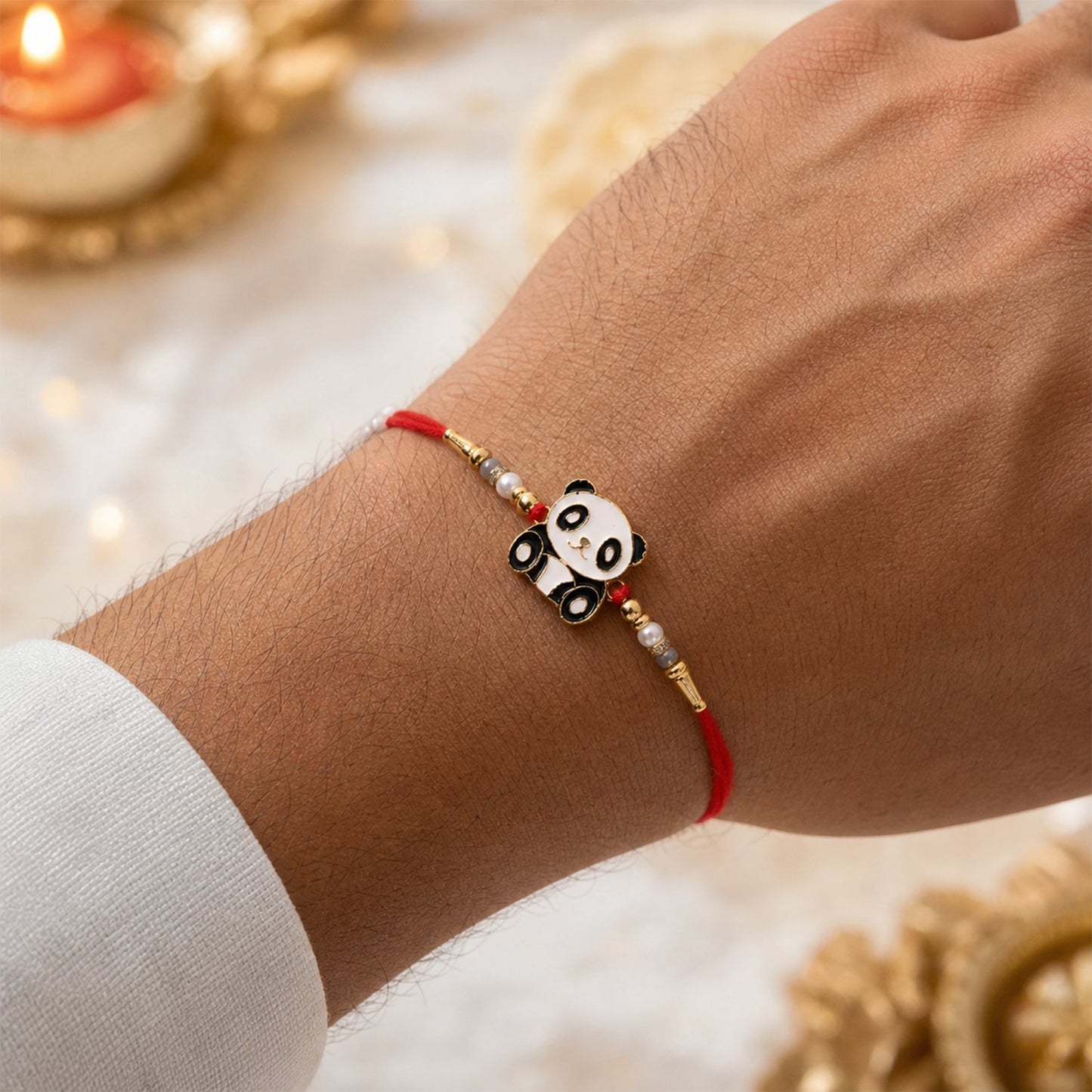 Side view of panda charm kids rakhi with pearls, festive accessory
