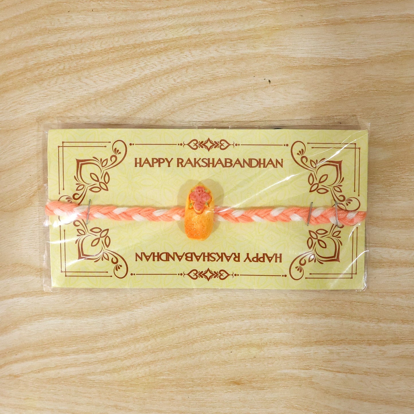 Festive Kids Rakhi featuring a charming cake design for Raksha Bandhan.