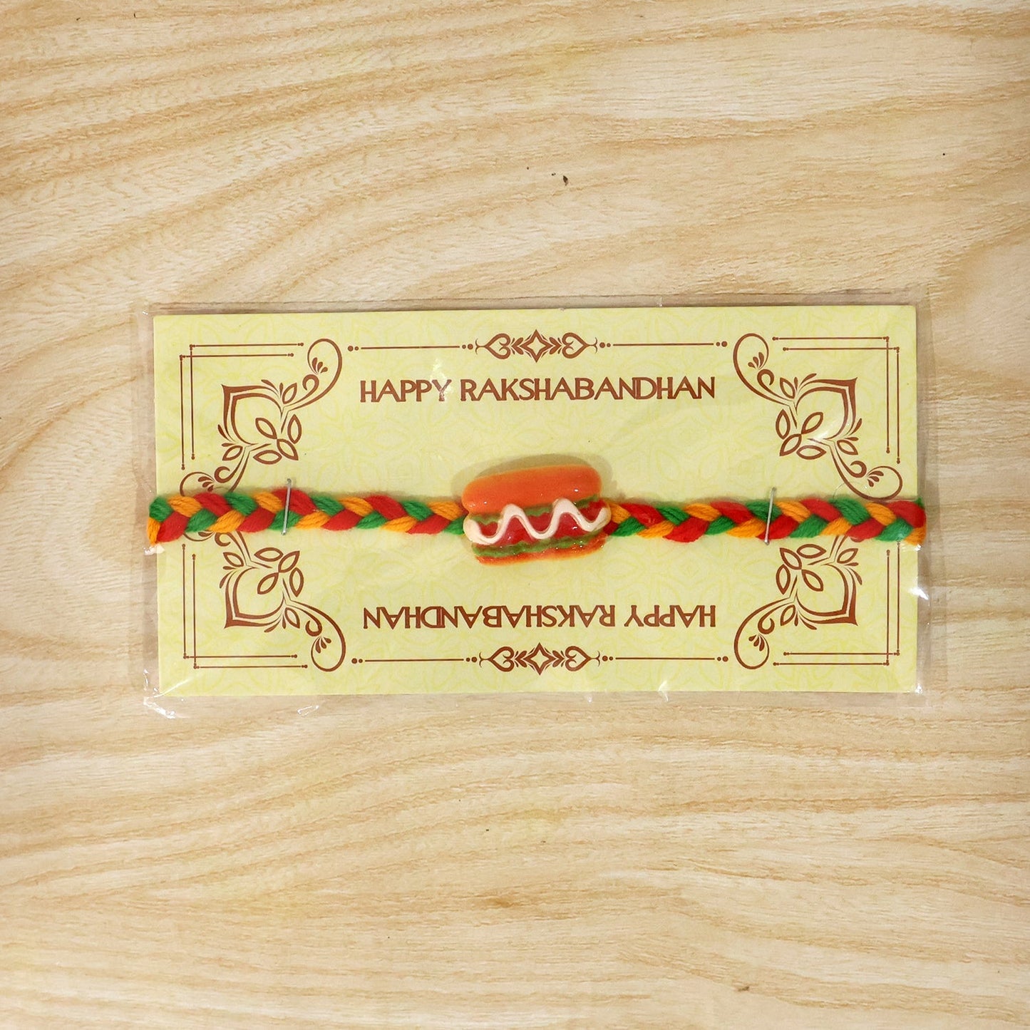 Lightweight braided thread Rakhi with playful food charms