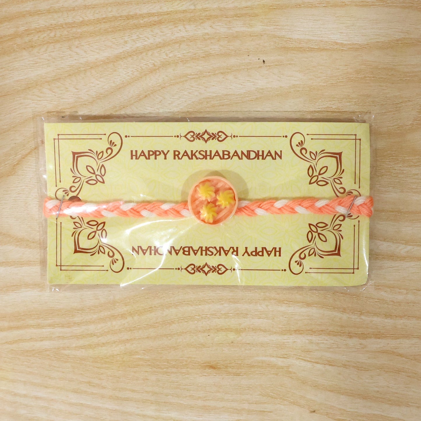 Round charm Rakhi elegantly displayed on white background