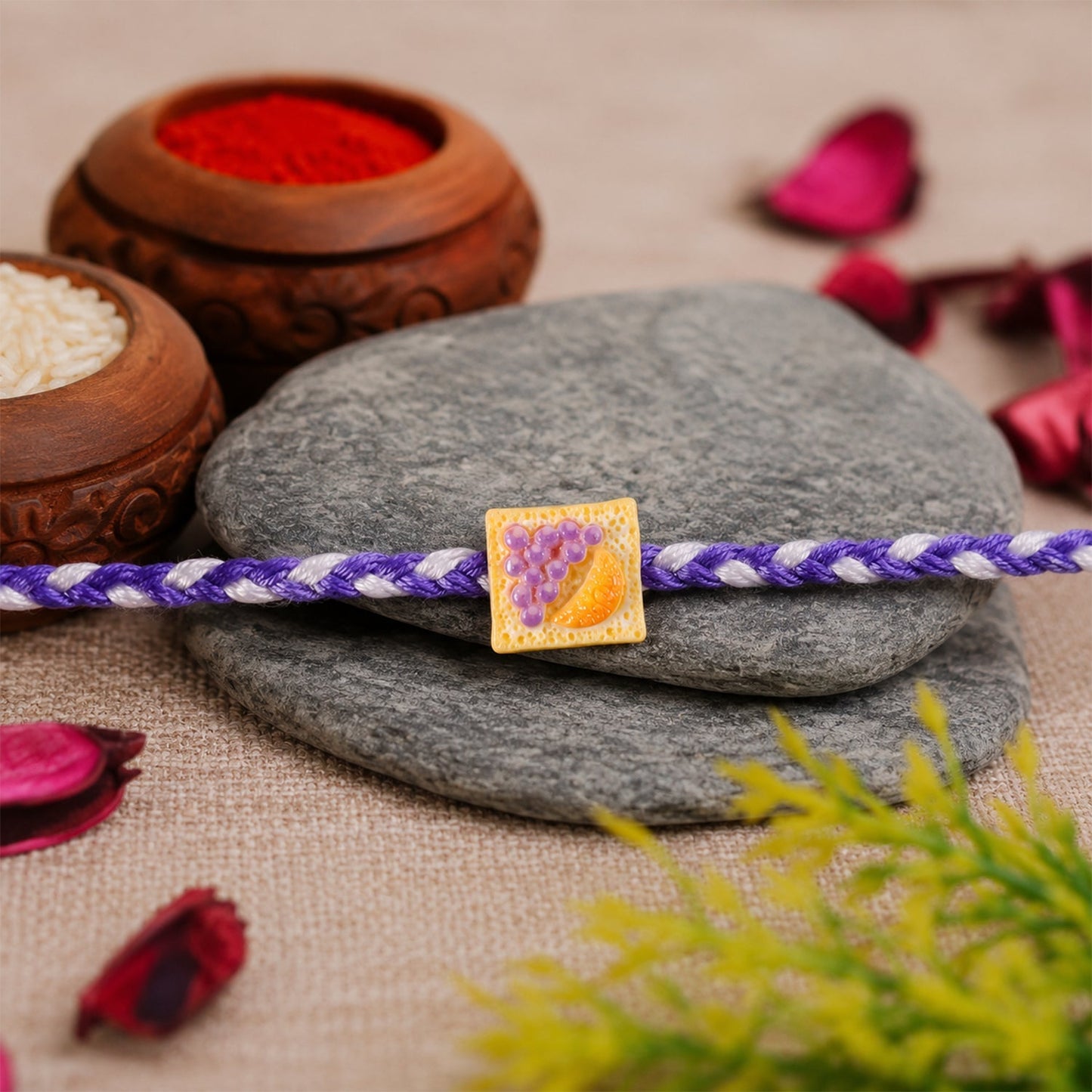 Side angle showing the braided thread and charm detail of Rakhi