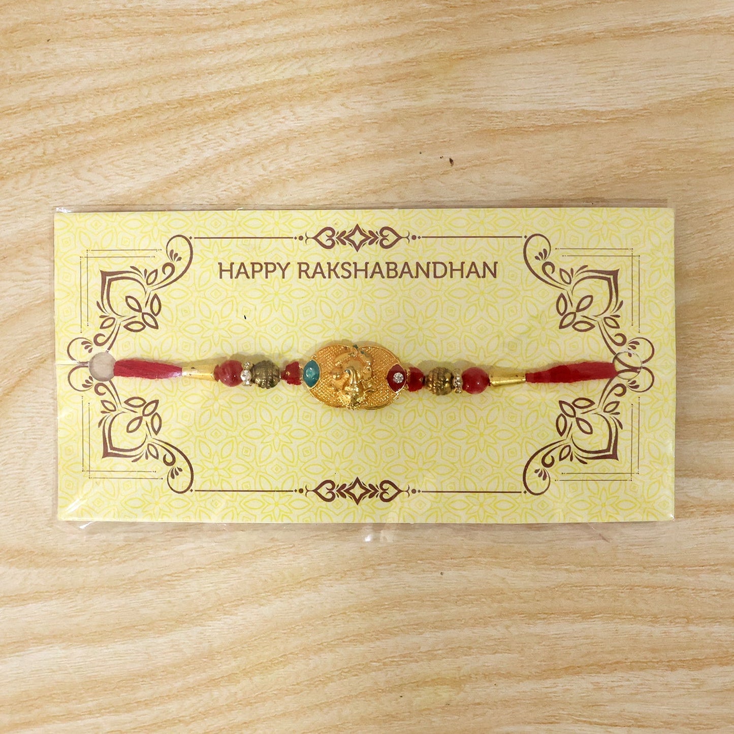 Detailed look at antique beads and Ganesh charm on Rakhi