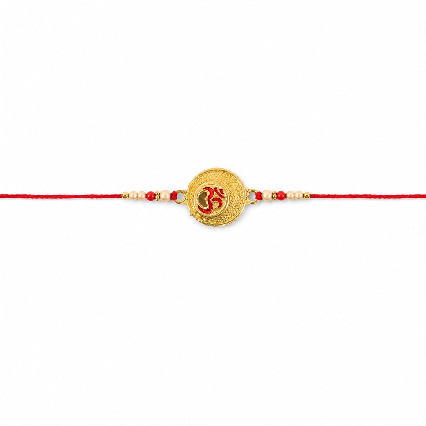 Close-up of Om engraved coin charm and pearl bead rakhi
