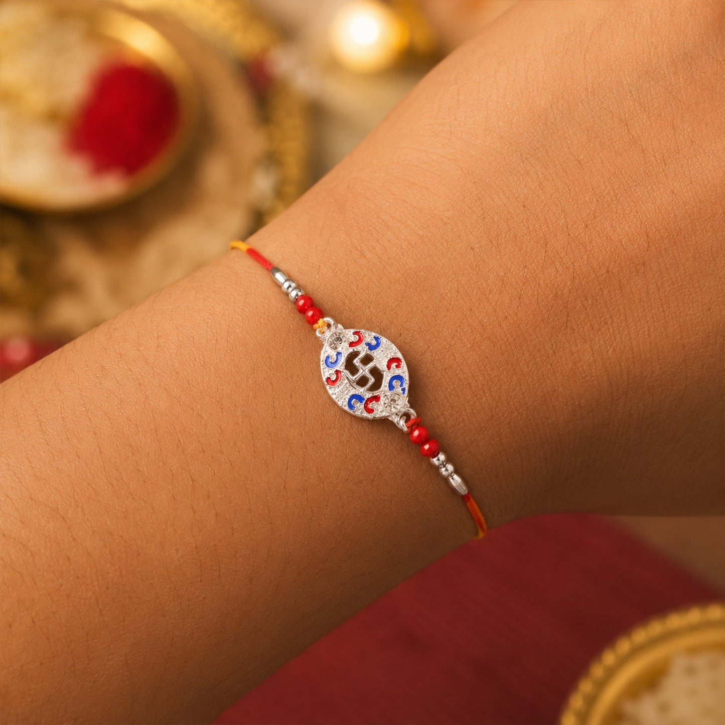 Thread and beads of Silver Swastik Meena Oval Charm Rakhi