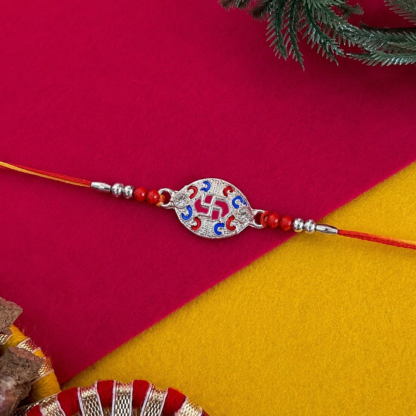 Side view of Silver Swastik Meena Oval Charm Rakhi with beads